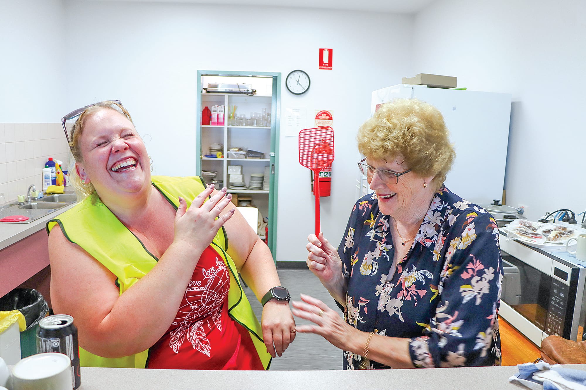 Alma Mattingley encourages fellow volunteer Kristen Ruddell to keep up the good work. A34_0224