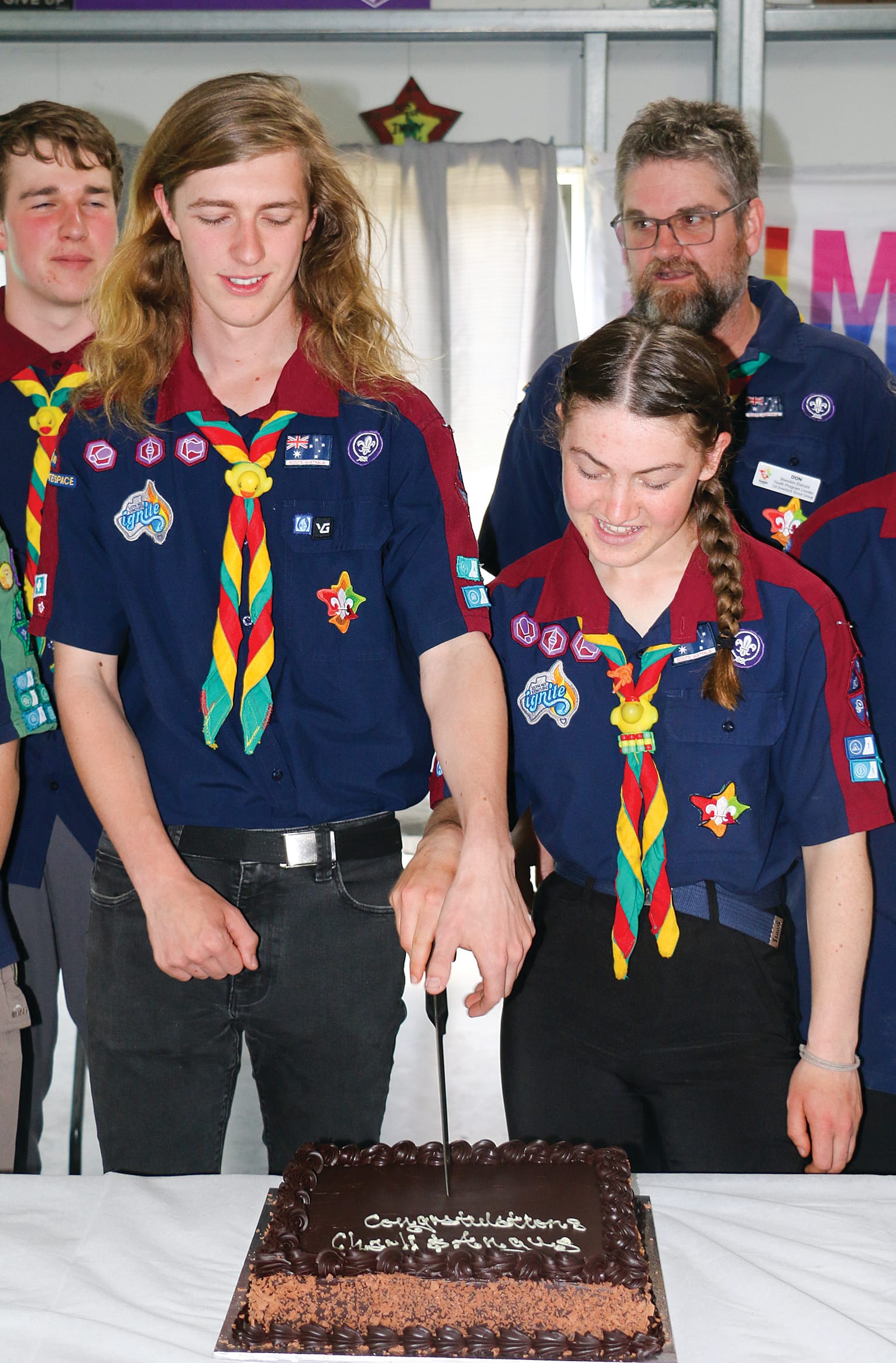 Angus McMillan and Charli Ogden cut the cake at their Queen’s Scout Award presentation on Saturday. tkScouts05_0724