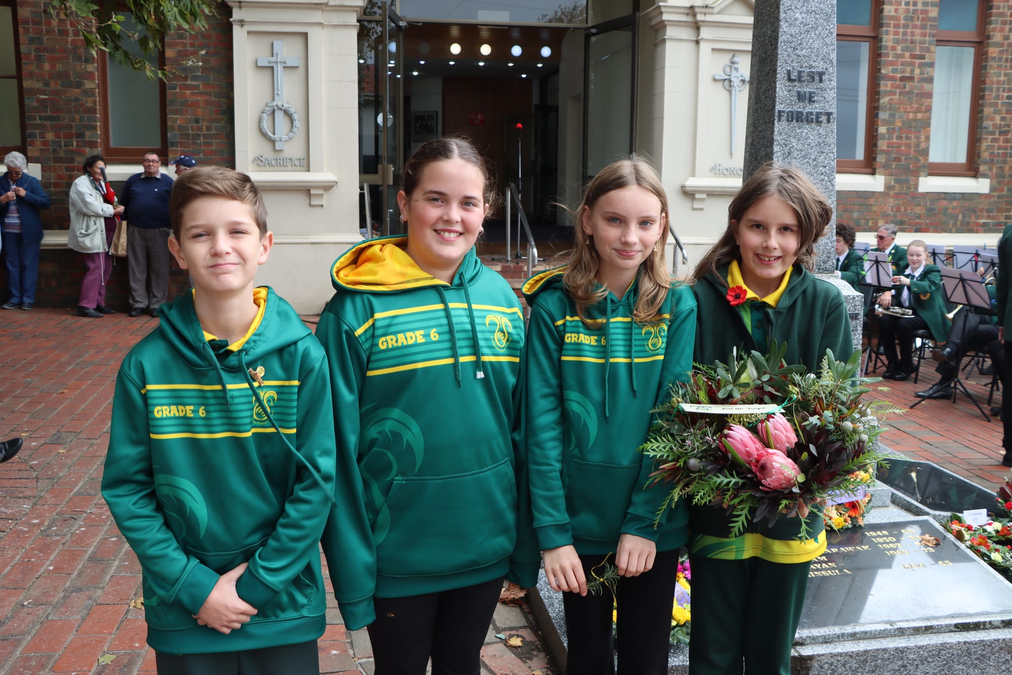 Leongatha Primary School Grade 6 students Ryan Perry, Piper Holt, Siiri Roberts and Charlotte Willis await the Anzac Day service in Leongatha.