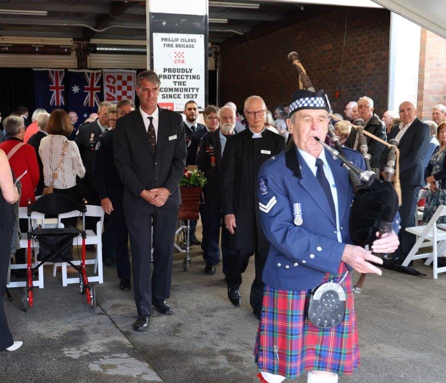 Police piper Ian Arrell OAM leads the funeral procession for Artie Murdoch out of the Phillip Island Fire Station after a moving service.