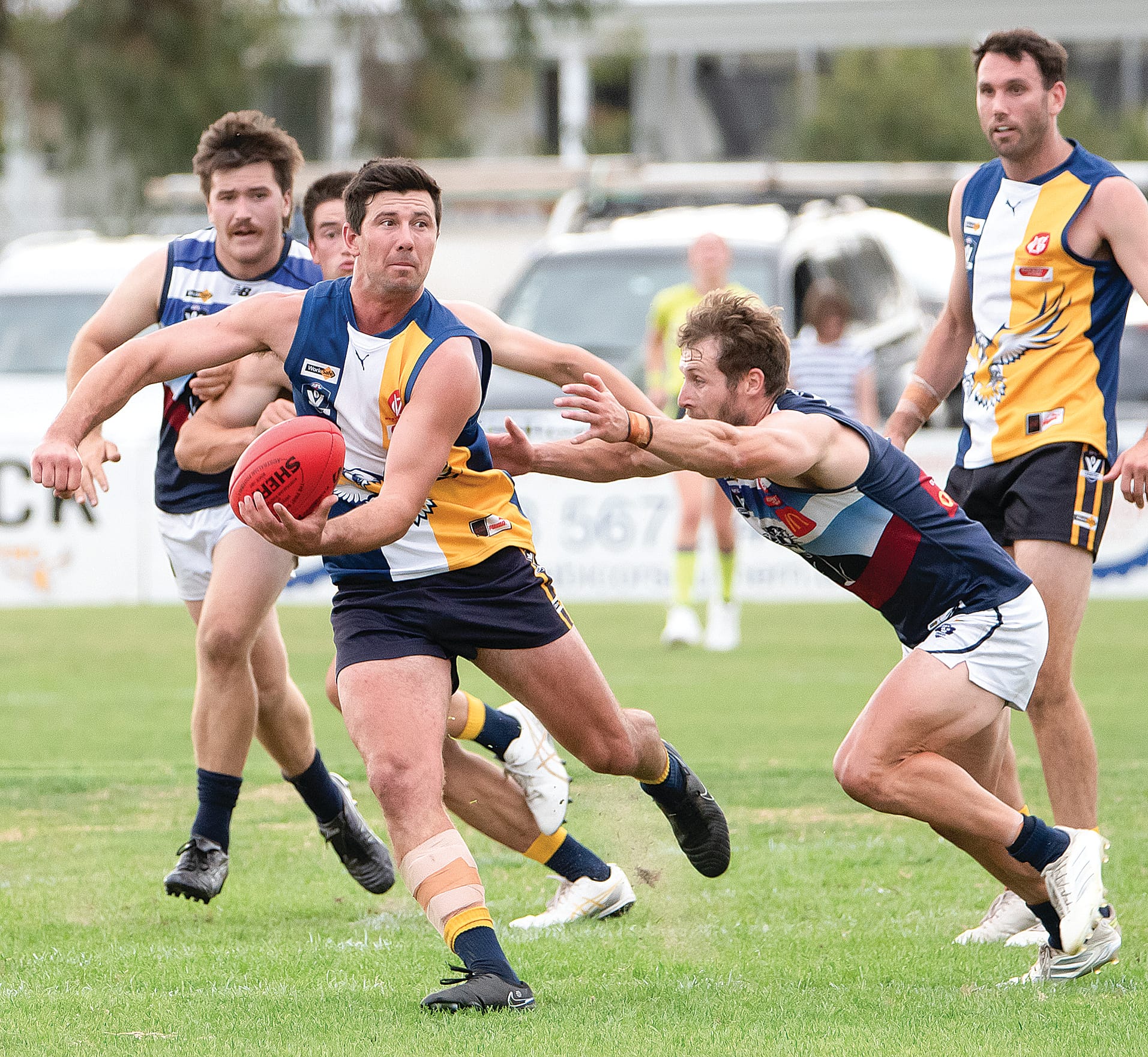 Ethan Park looks for an option to offload a handball as Nathan Foote (Kilcunda Bass) prepares to pounce. Photos: Anna Carson