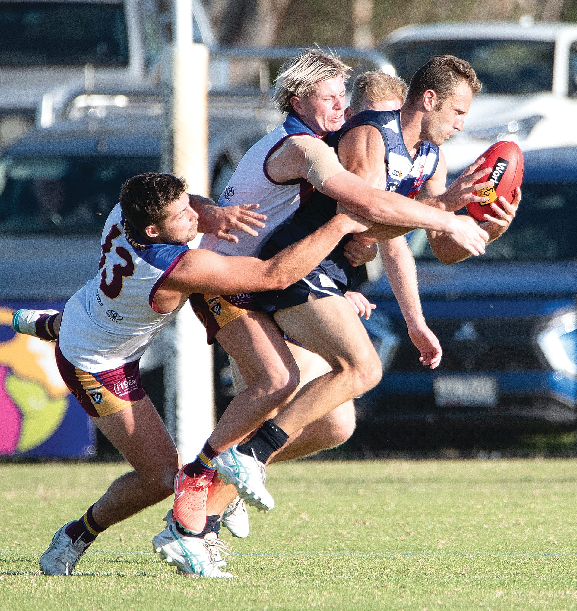 Travis Tuck attempts to break through strong defensive pressure from his Dusties opponents.
Photos: Anna Carson