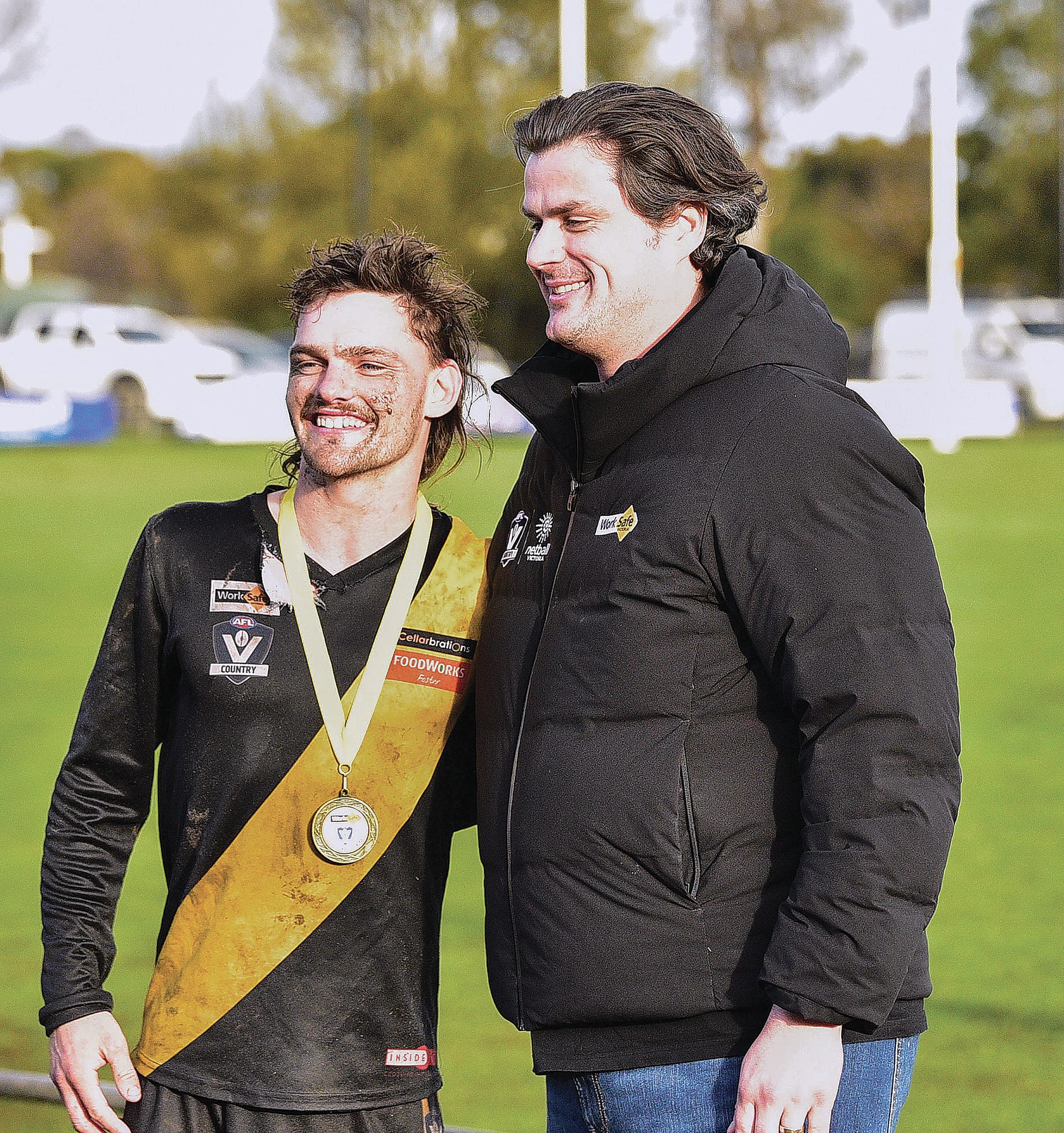 Best on Ground Gus Norton is congratulated by Western Bulldogs’ Premiership player Tom Boyd who was part of the presentation for the Work Safe Round.