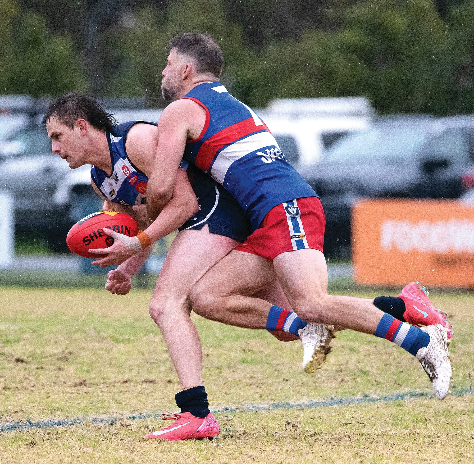 Steven Scott feels the pressure from Phillip Island’s Jaymie Youle as he looks to dispose of the ball. Photo: Anna Carson