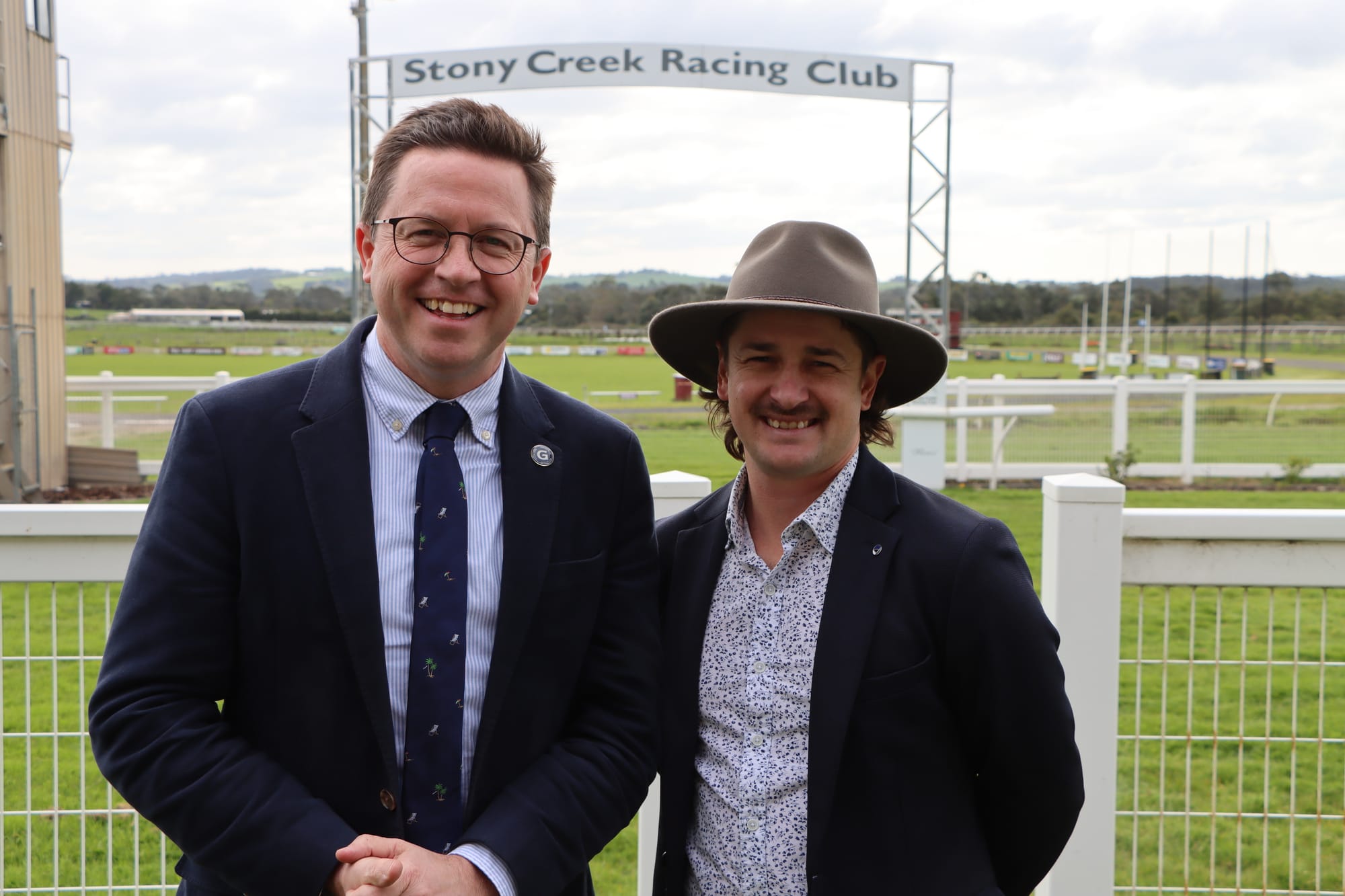 Minister for Racing Anthony Carbines and Stony Creek Racing Club CEO Jason Benbow stand near the track that now features a new irrigation system.