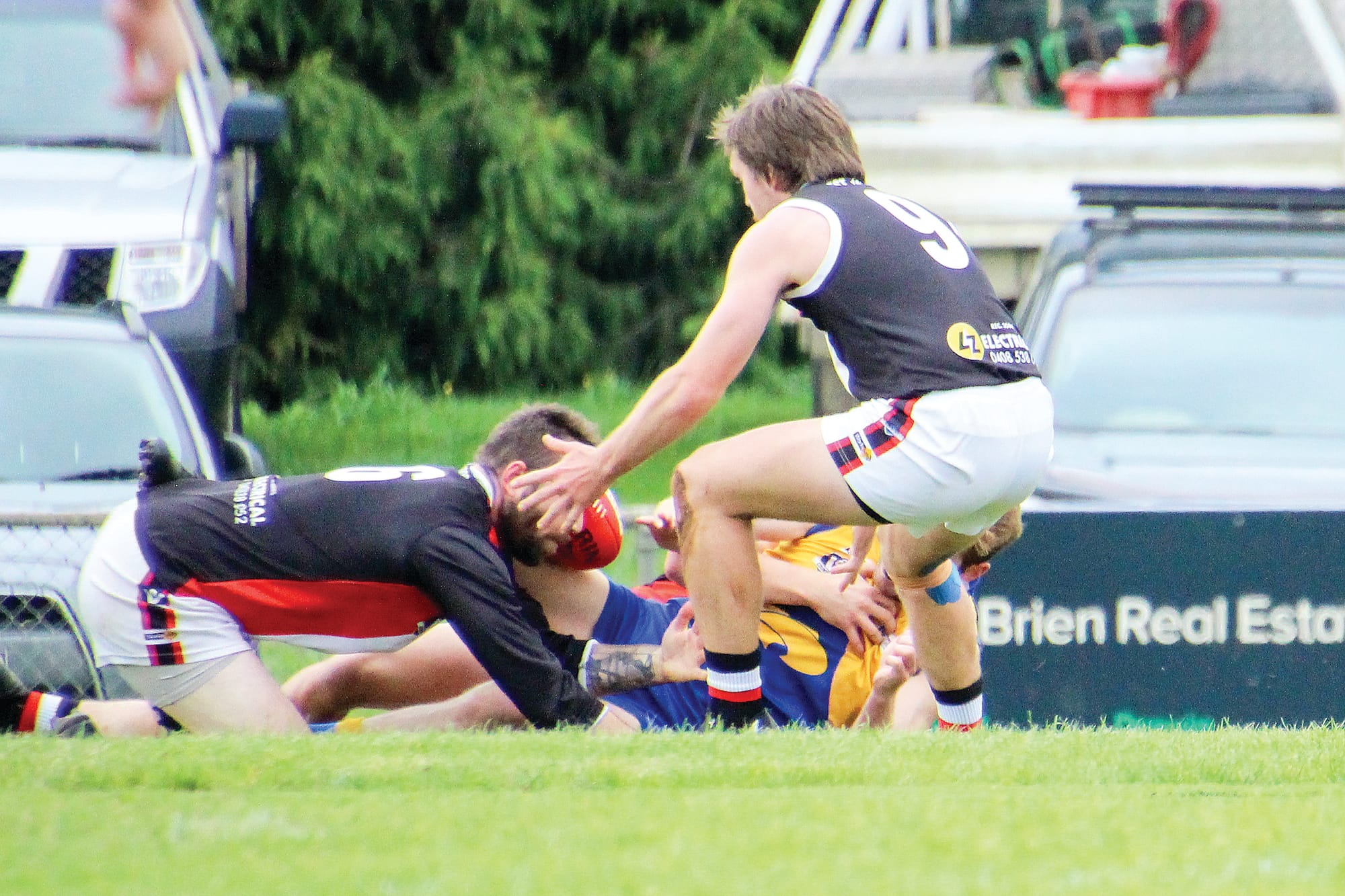 Brothers Dylan and Jesse Heylen wrestle for possession.