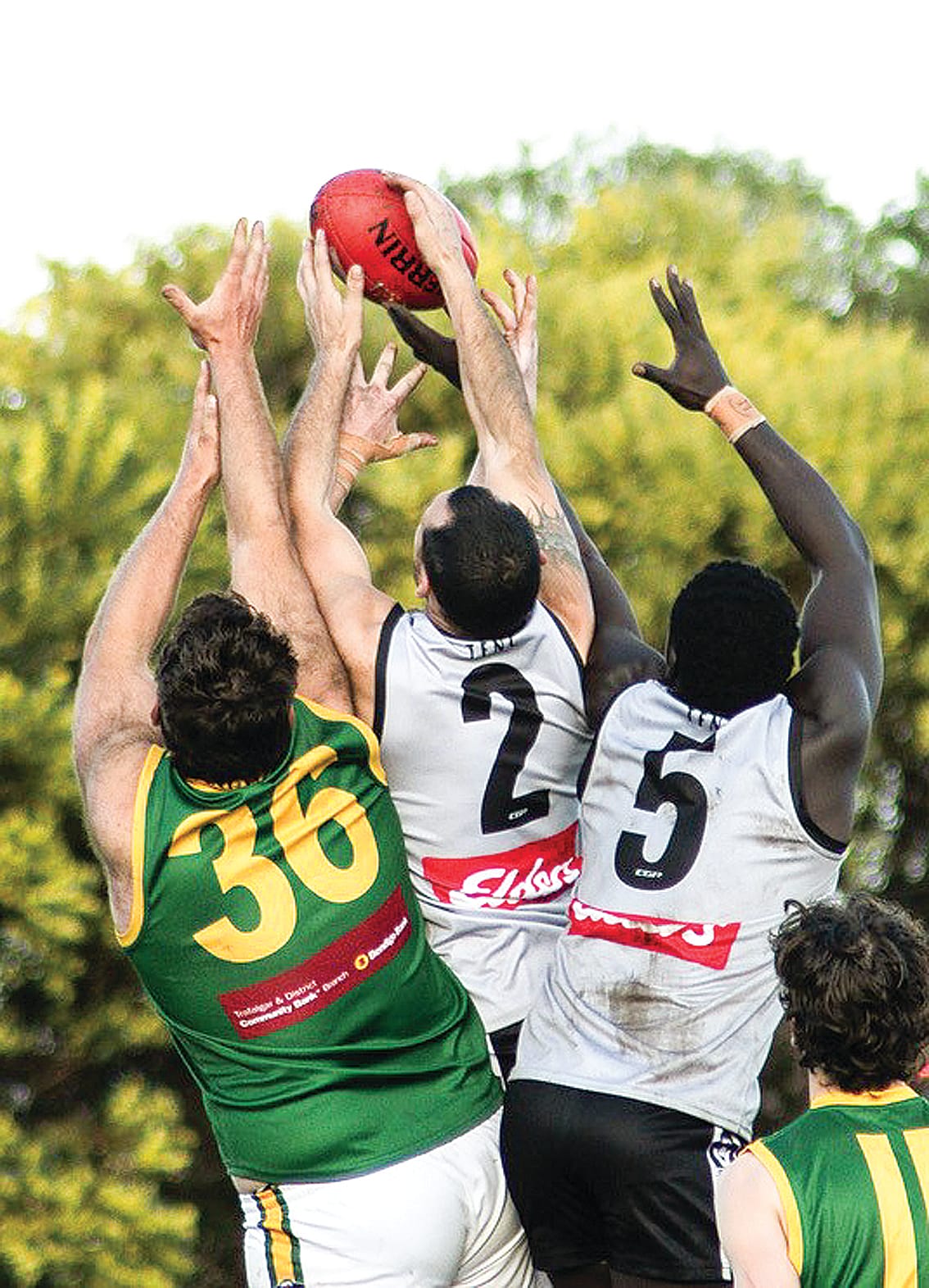 Magpies’ Peter Grant and Majok Puok fly for the ball.