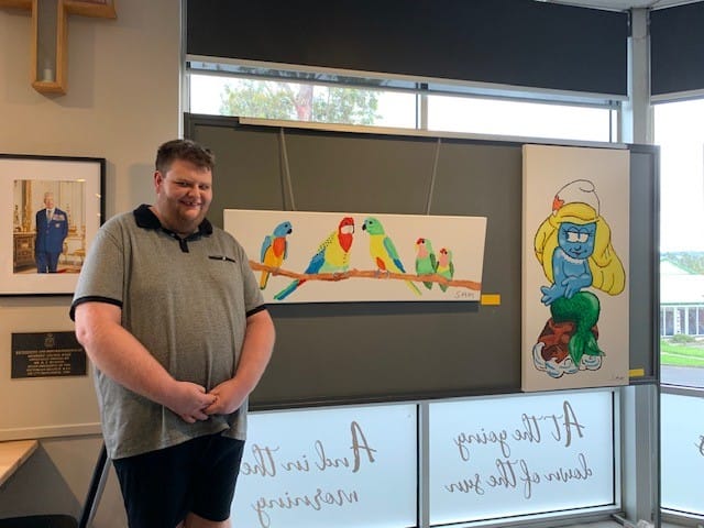 Sam Lennon with his art work Birds and Mermaid Surfette