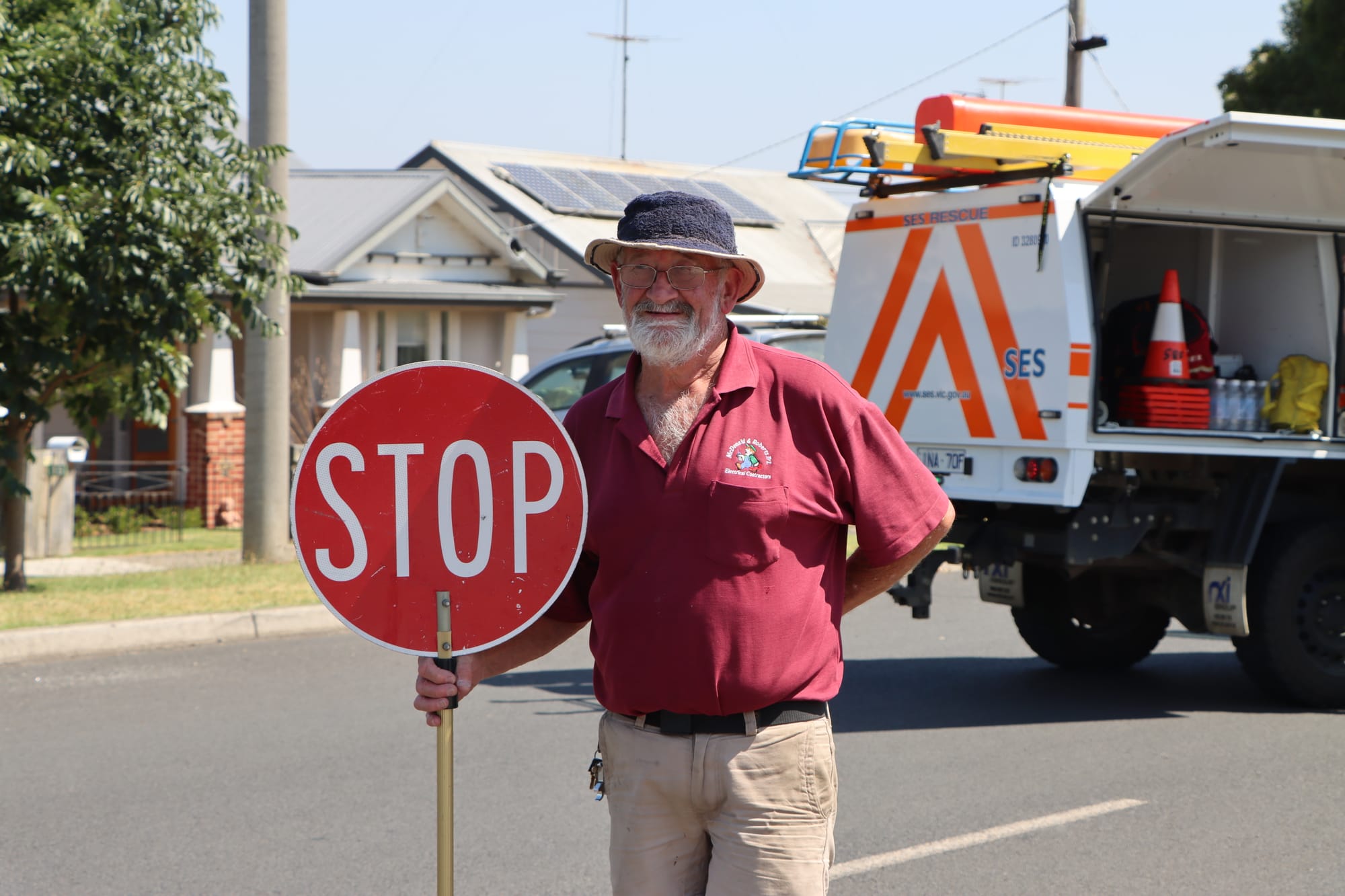 Local electrician Grant McDonald helps keep traffic away from the downed wire.