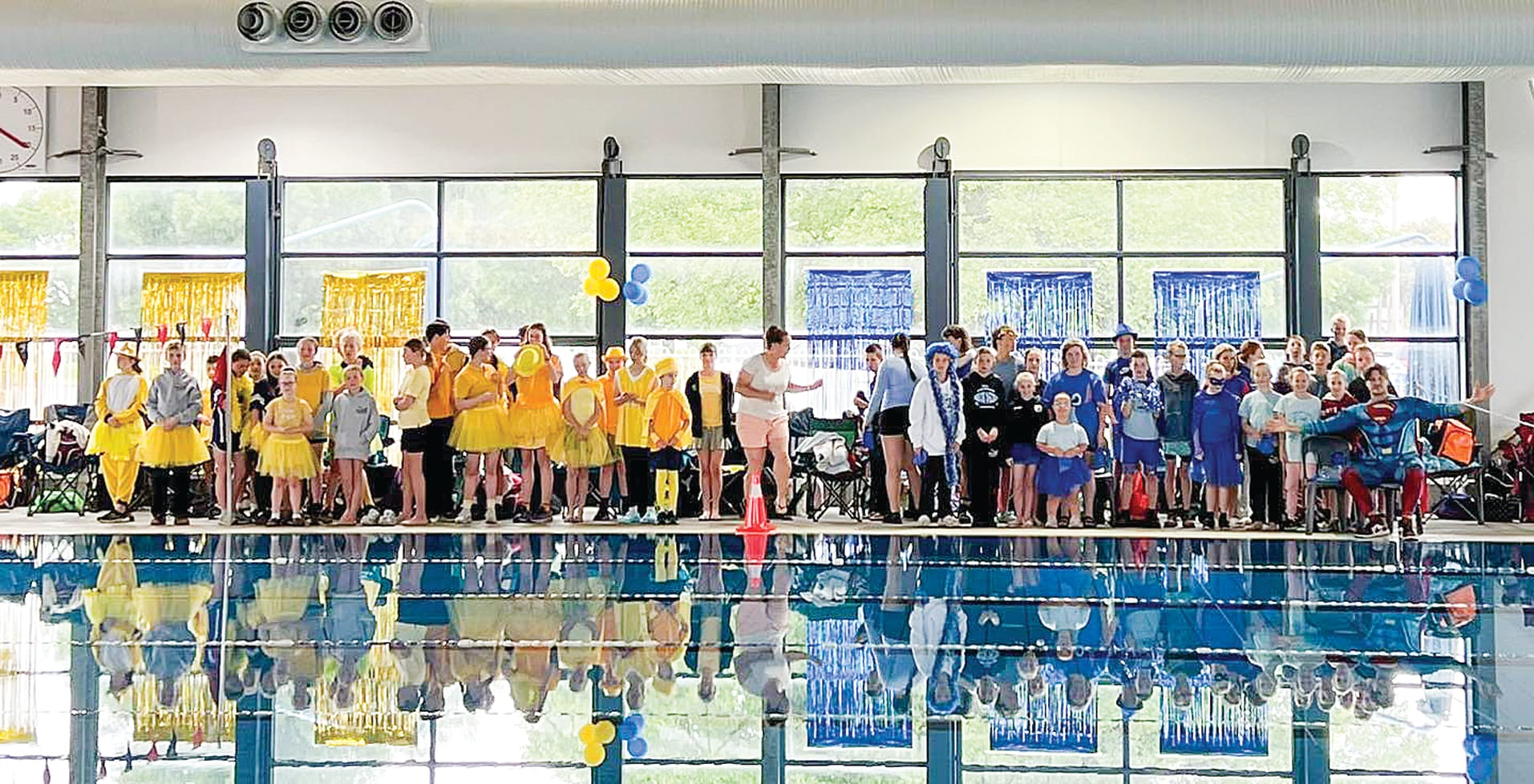 The yellow and blue teams cheered on their teammates.