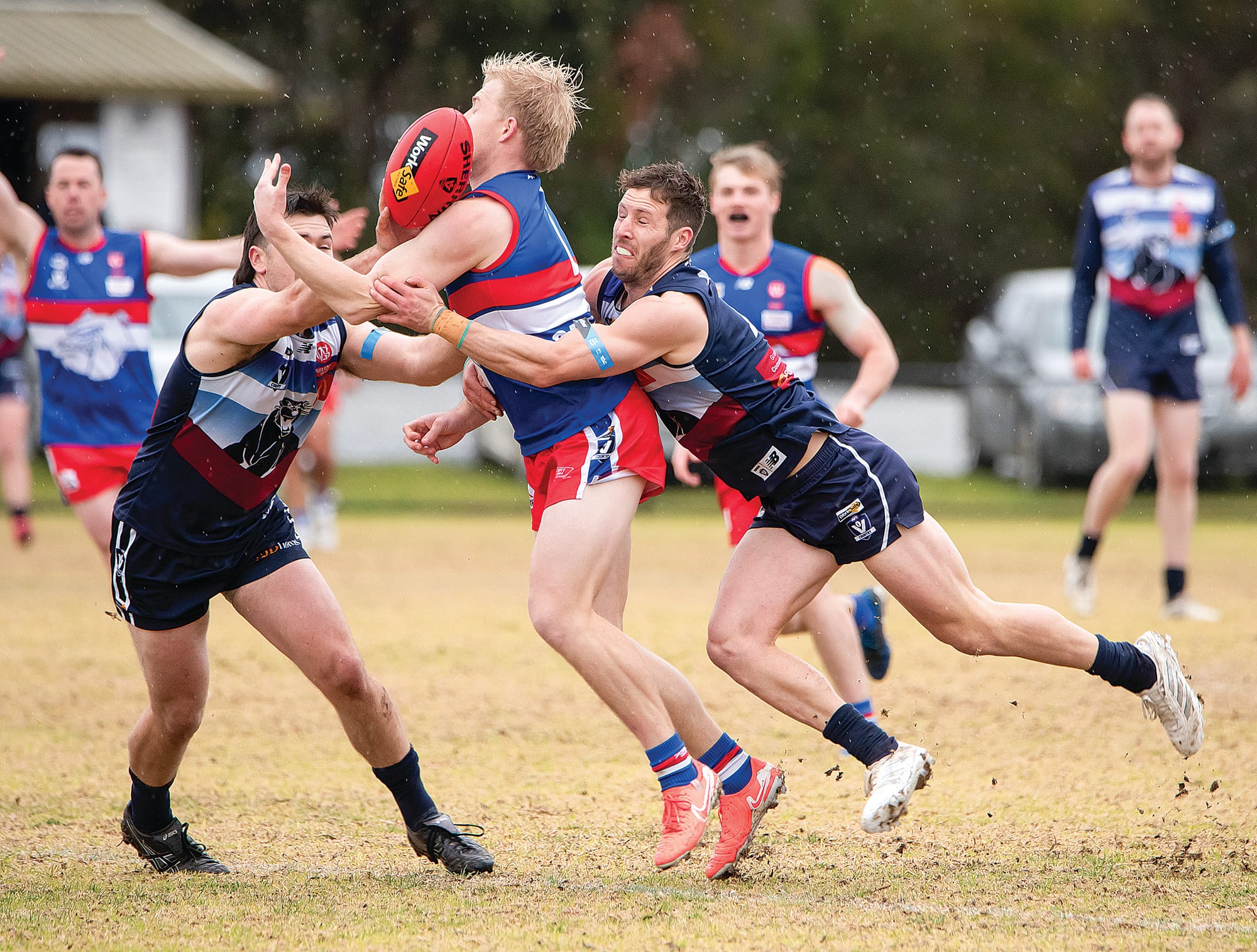 Lachlan Burns and Nathan Foote apply the pressure as they close in on Phillip Island’s Hayden Bruce. Photo: Anna Carson