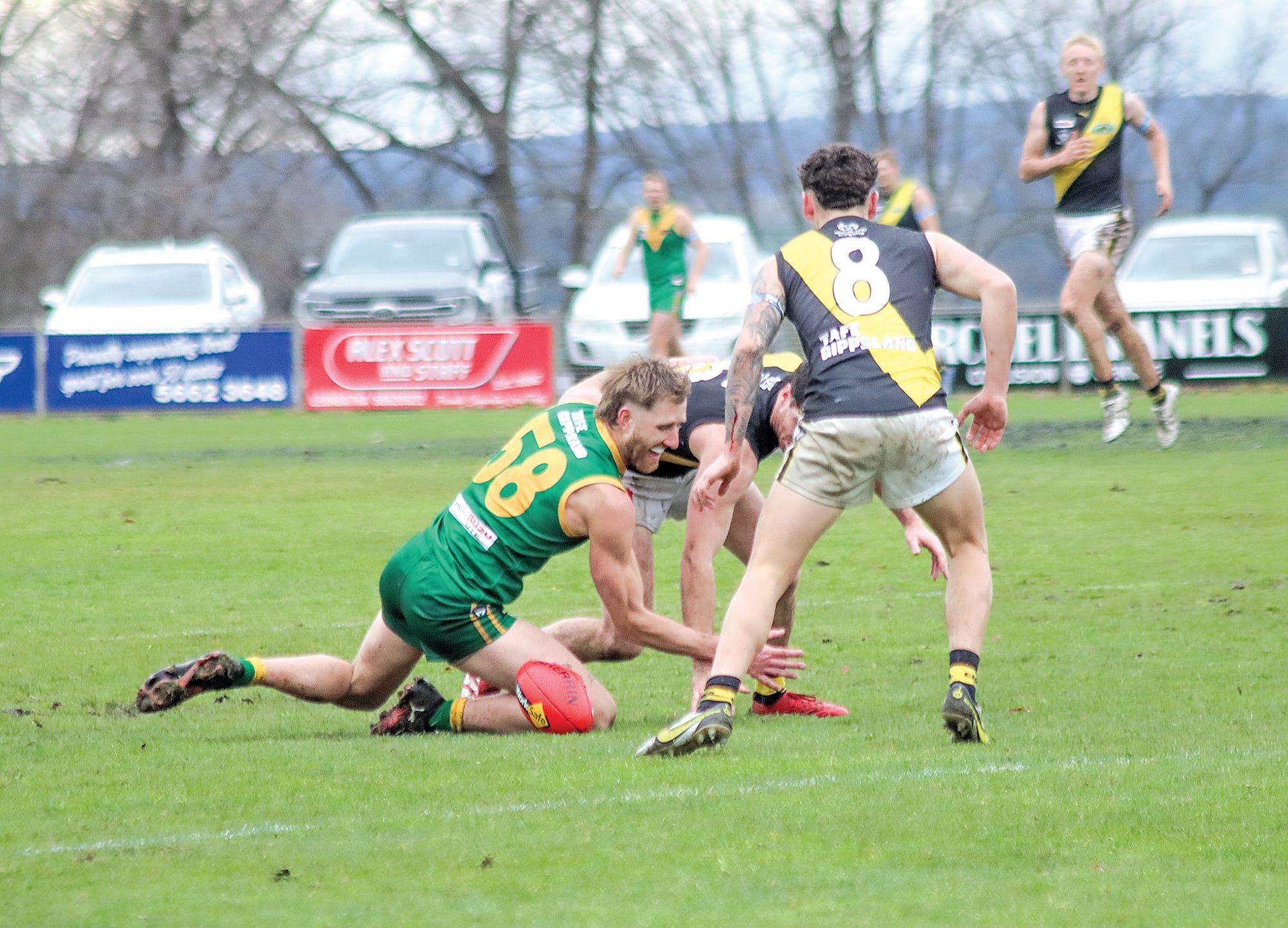 Dyson Heppell battles a couple of Tigers in Aidan Quigley and Blake Couling, Quigley being his side’s best. A31_3025