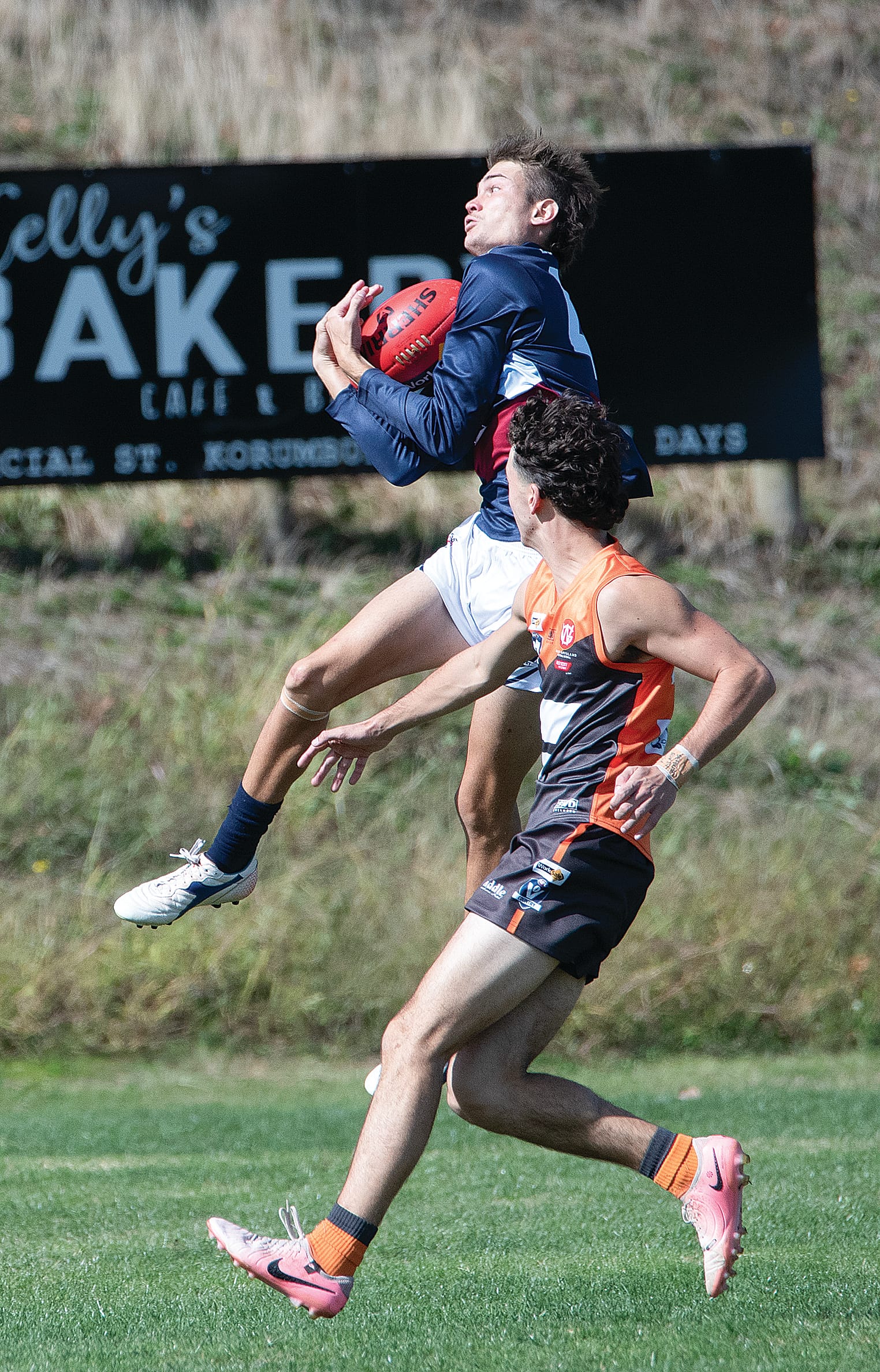 Owen Thomas takes a mark in front of Zachary Barrett in the middle of the ground.