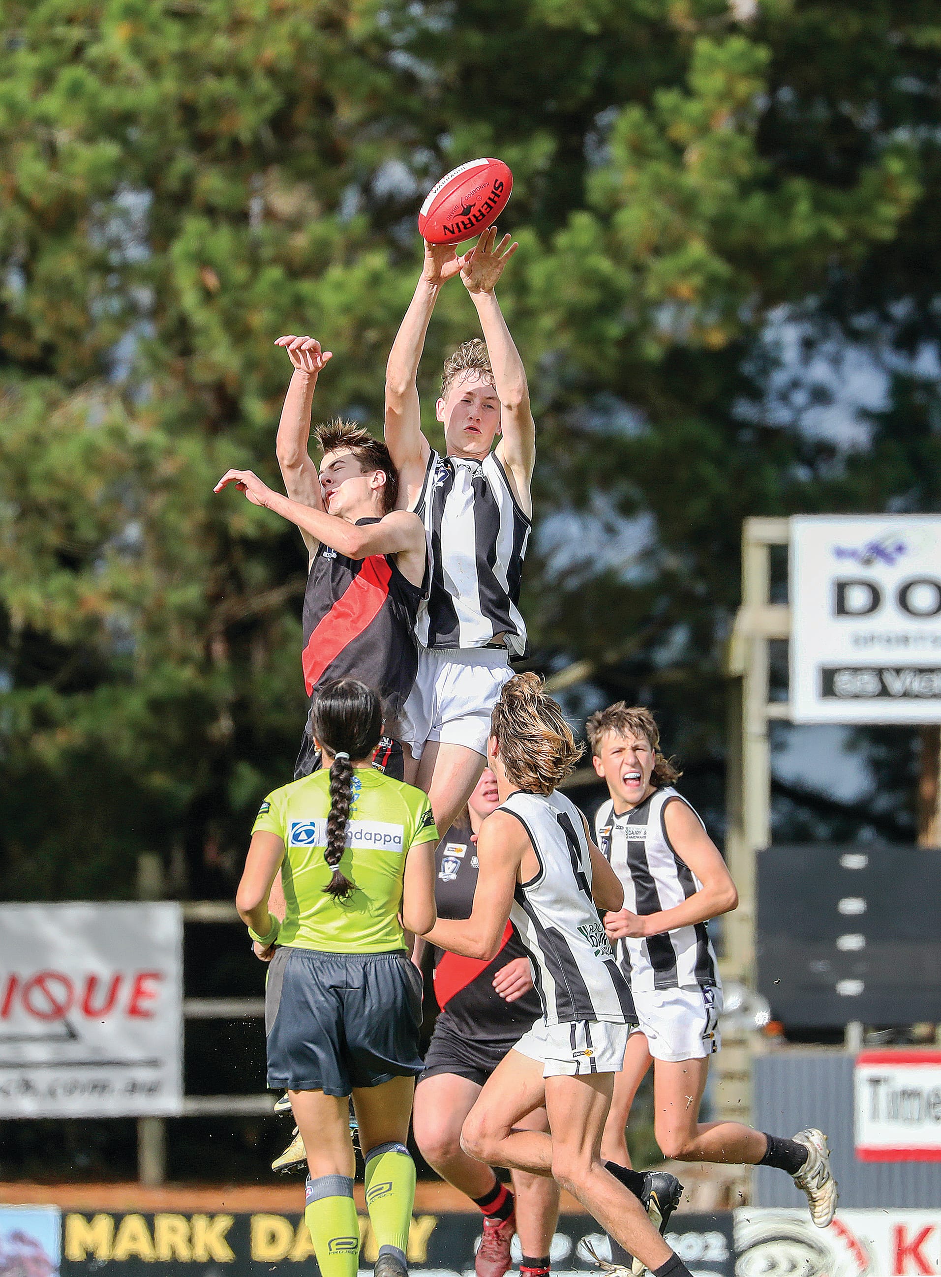 Poowong’s Kohen Mandemaker takes a specie in the ruck contest.