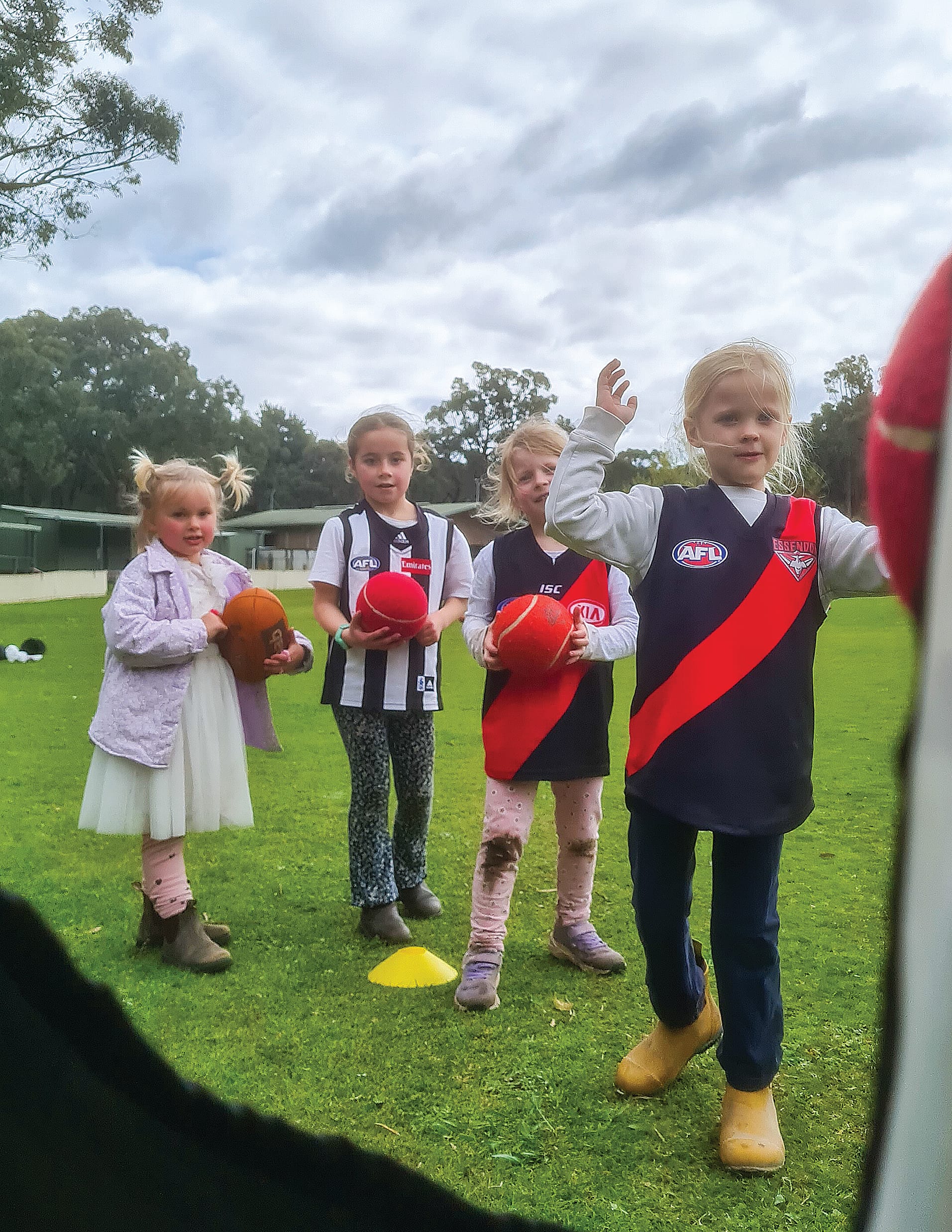 Harper White hits the handball target while Daisy, Taylor and Harriet watch on.