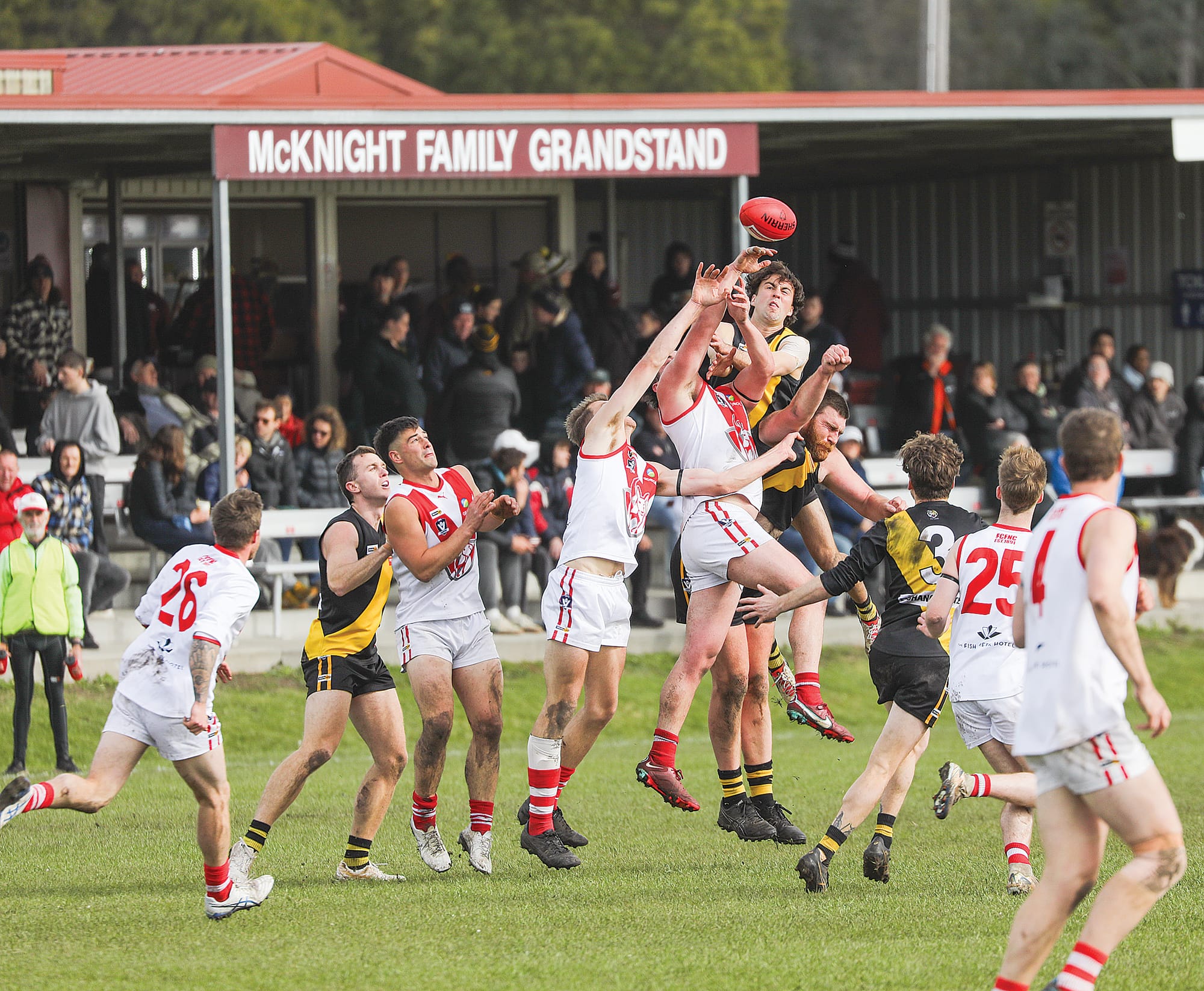 Kangaroos and Tigers leap during the second quarter of a low-scoring semi-final won by Fish Creek over Foster. A02_3525