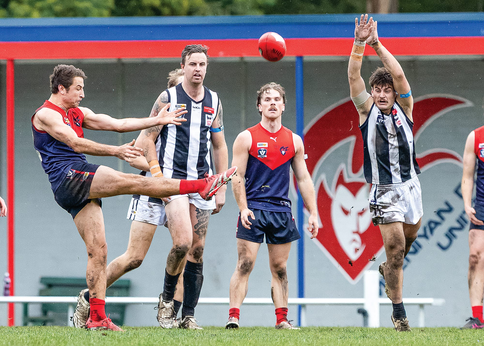 Sam Wilson kicks the Sherrin down the line for MDU. Photo: Bec Casey Sports Photography. 