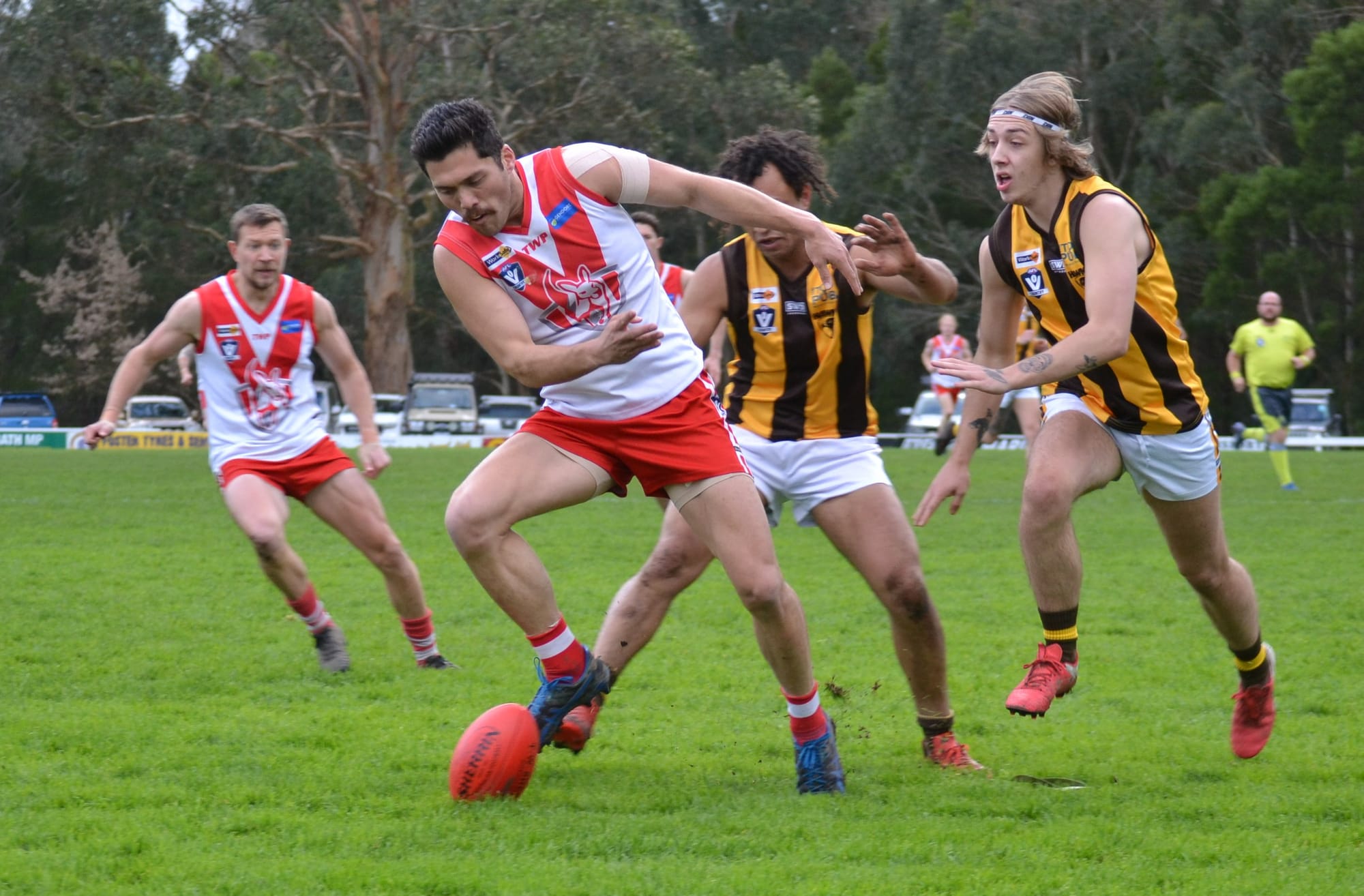Fish Creek’s Pat Pekin with eyes on the ball ahead of two Morwell East opponents.