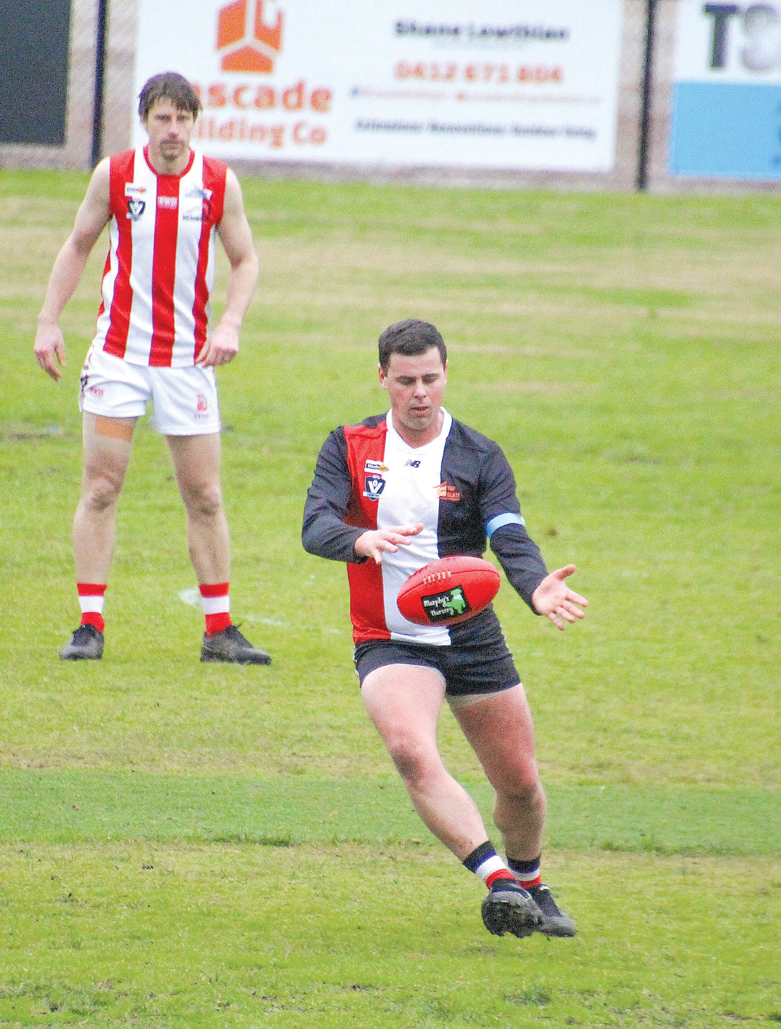 Sam Dixon send the ball into Nyora's forward line.