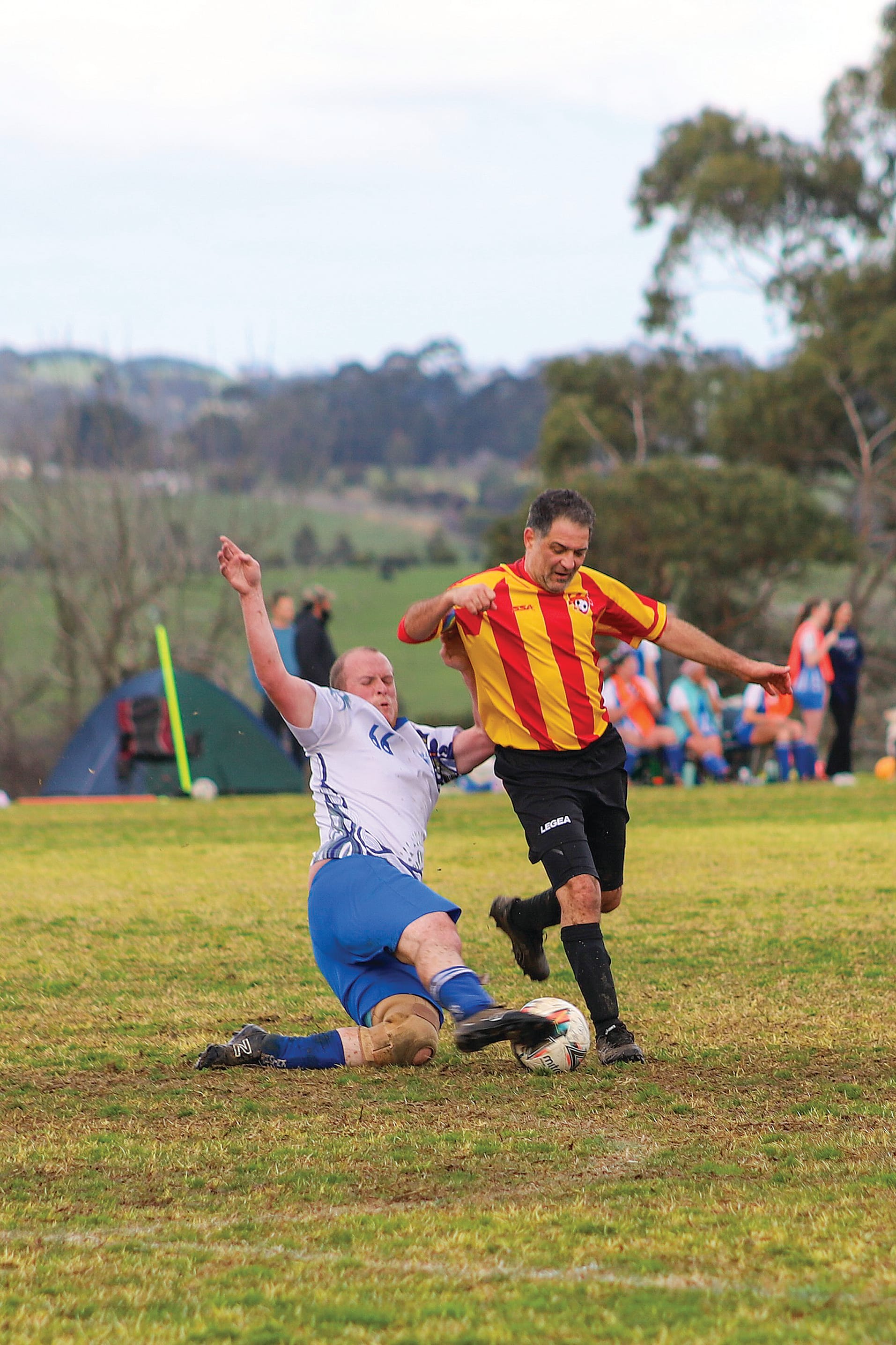 Midfielder Charlie Dougherty pulls off an impressive slide tackle against Inverloch’s Gene Parini. 
