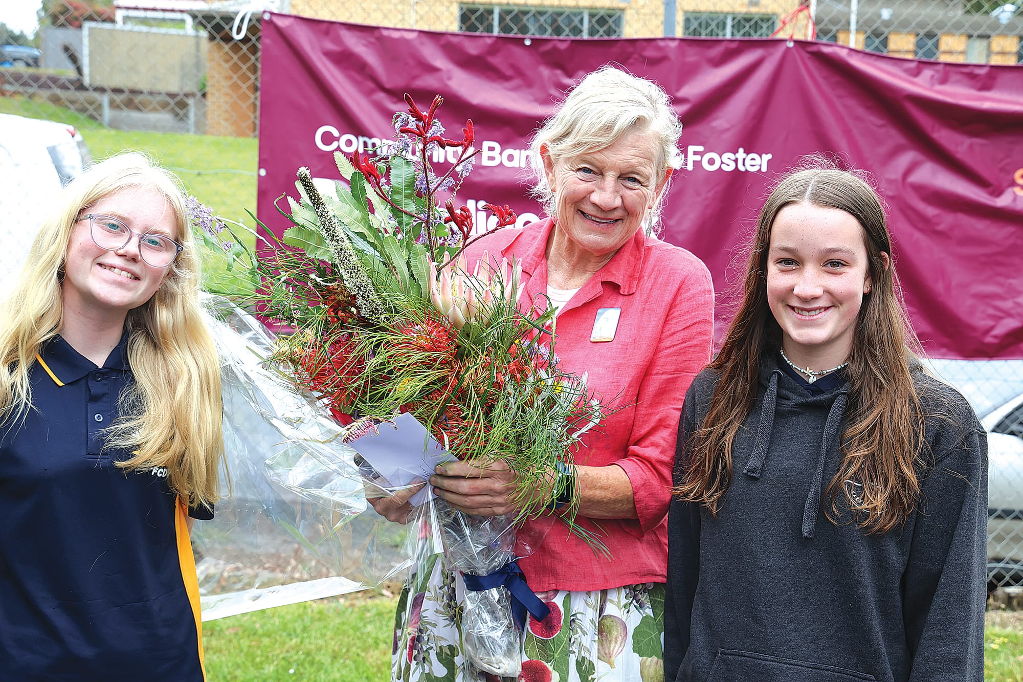 Fish Creek Primary School students Chloe Littlejohn and Addie Manne present award-winning local children’s author Alison Lester with some birthday flowers at the Fishy Stories Festival on Sunday.