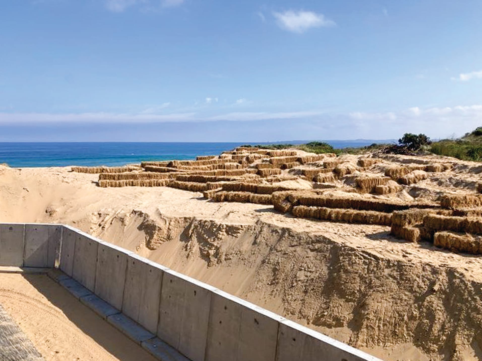 Sand wall works at the Woolamai Beach Surf Life Saving Club.