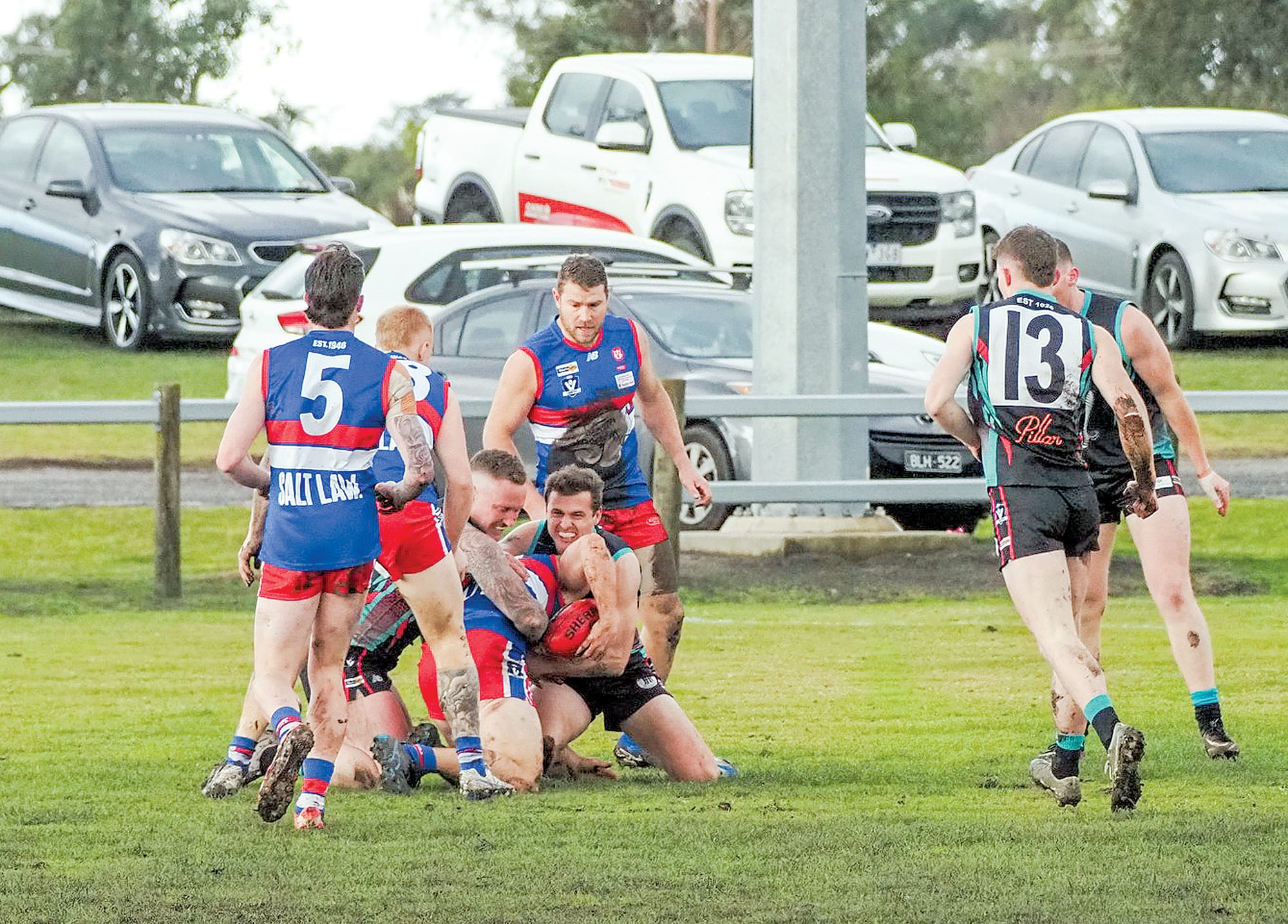 Cora Lynn players double up to smother the Phillip Island player. 
