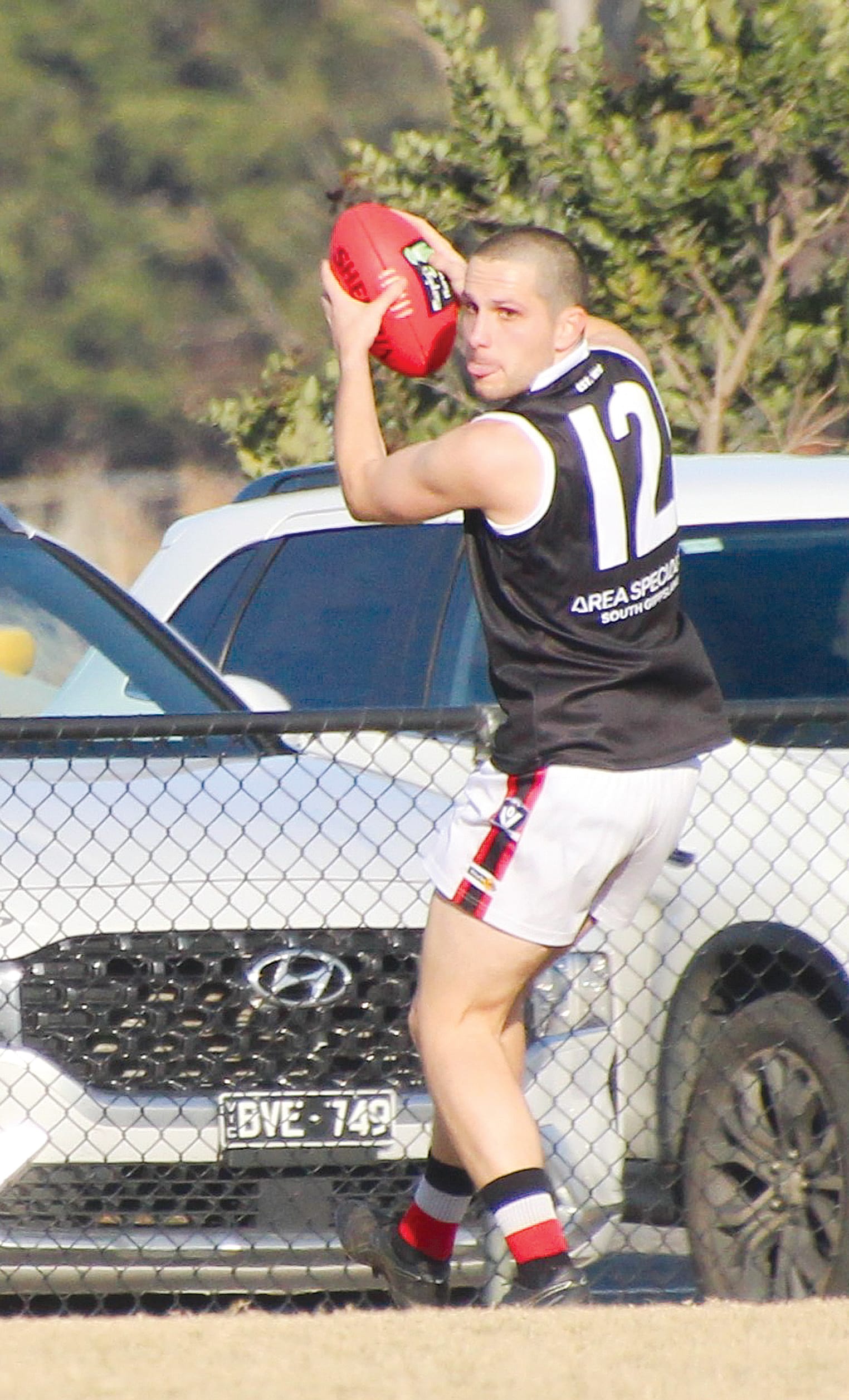 Fletcher Kennedy clear the ball out of defence. 