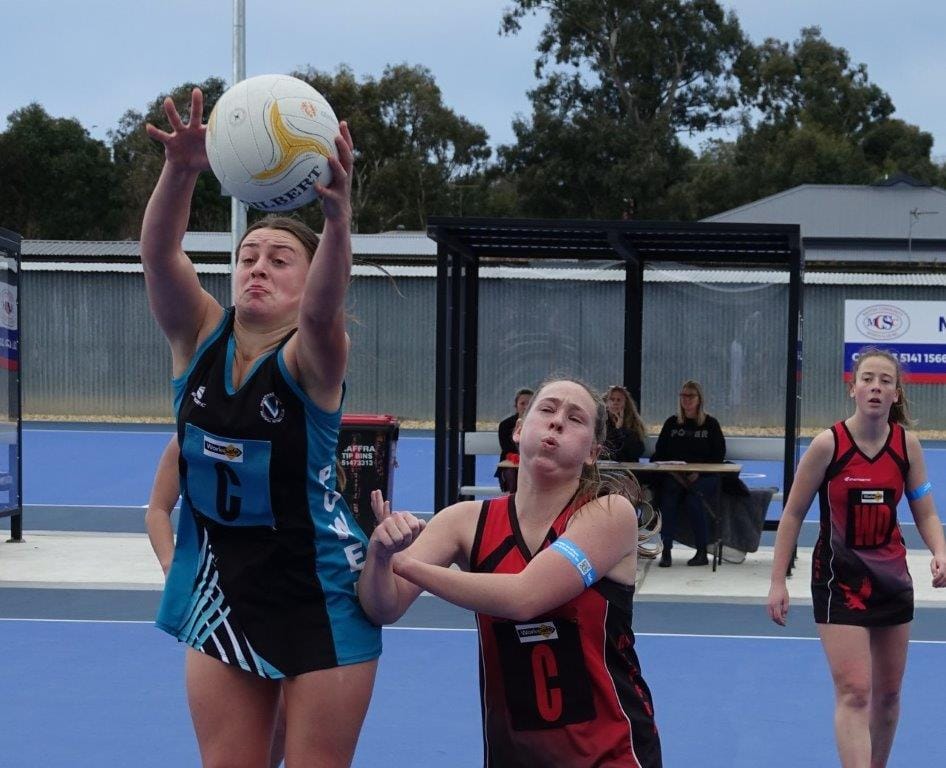 Wonthaggi B Grade Centre Bella Anderson puts everything into taking possession of the ball ahead of Maffra’s Rebecca Bourke.