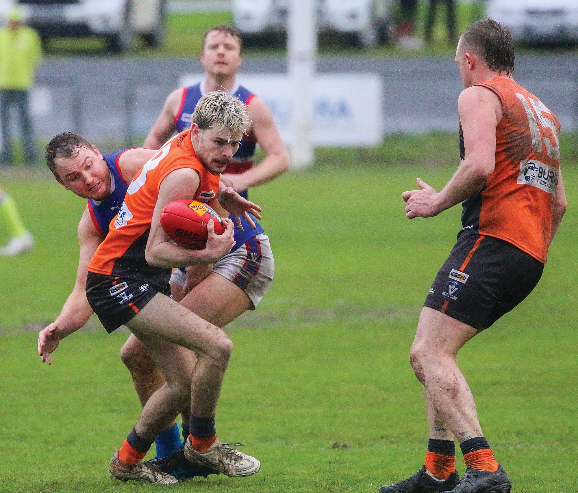 Korumburra-Bena’s Lachlan Smith shielded the ball from his Bunyip opponent.