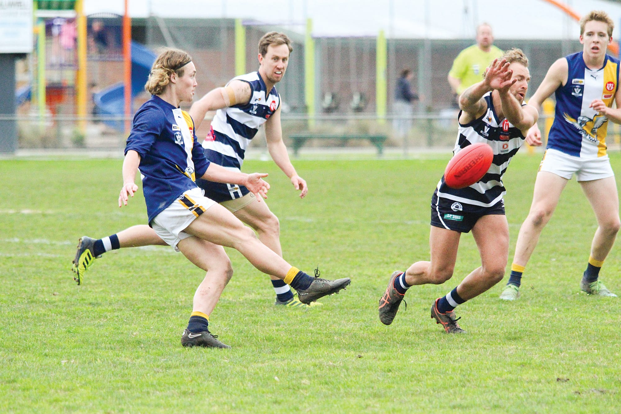 Corey Casey gets the kick away under pressure. 