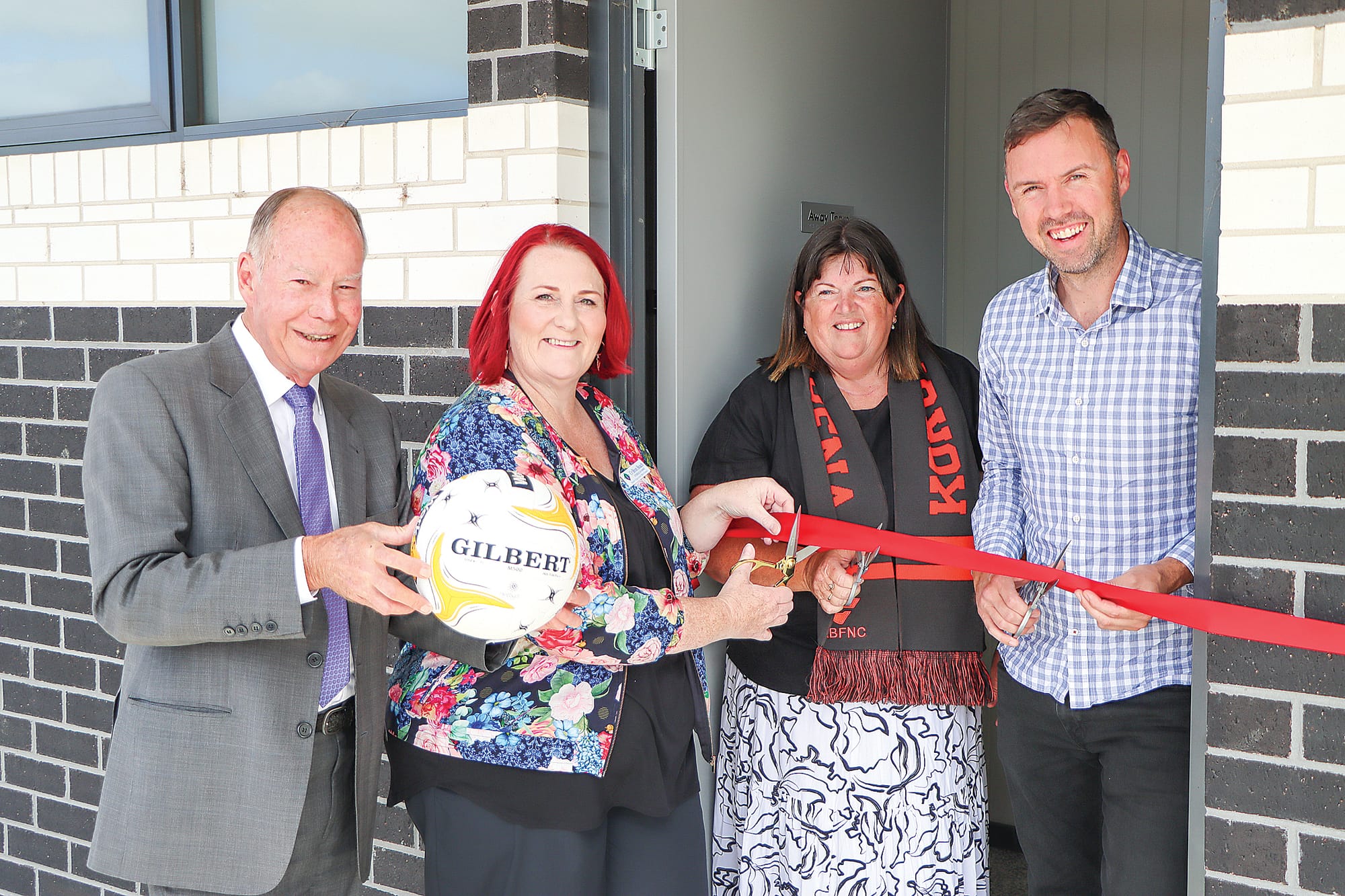 Member for Monash Russell Broadbent, South Gippsland Shire councillor Bron Beach, Korumburra-Bena Football Netball Club secretary Nadine Smith and Member for Eastern Victoria Tom McIntosh get set to cut the ribbon on the new netball building at the Korumburra Showgrounds. A25_1225