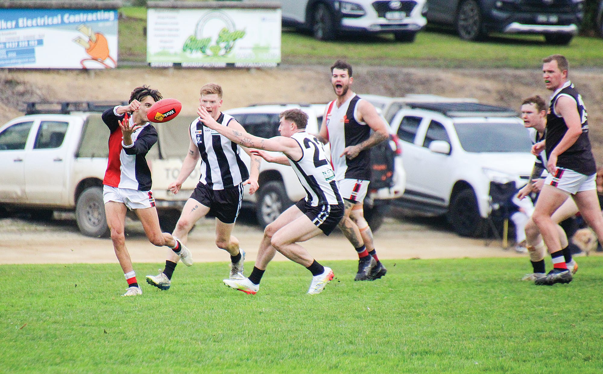 Nyora’s Marley Huet executes a handball under pressure from Poowong. 
