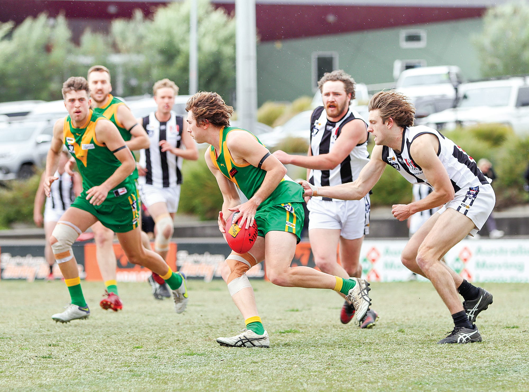 Mason McGannon strives to break free for Leongatha. 