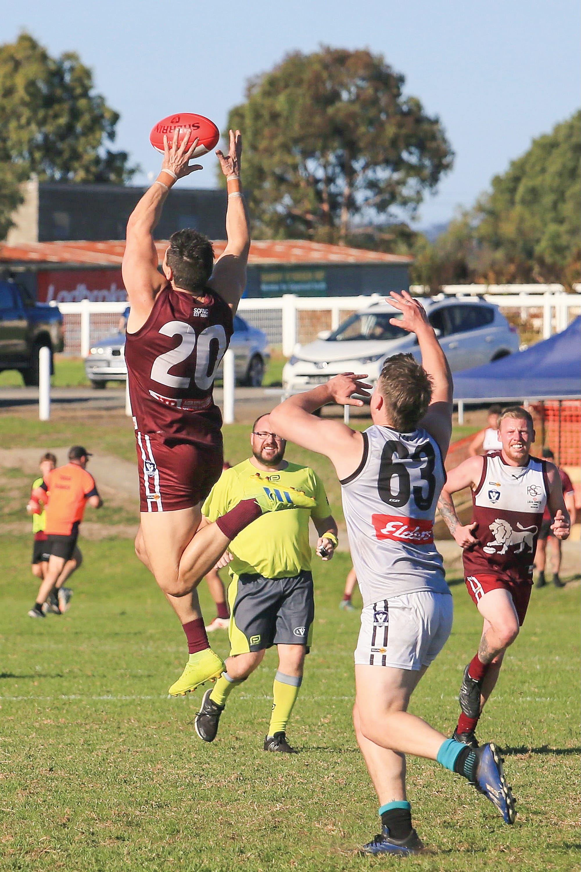 Kael Burgles leaps for the ball in front of Fergus Cashmore as Jack Stuart watches on. Photo: G. S. Bruning.