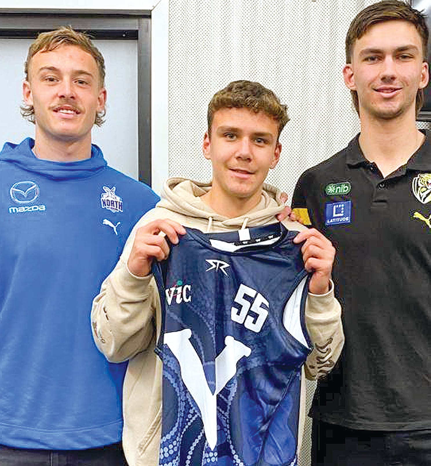 Connor McMillan is presented his Victoria White jumper by Josh Goater (left) and Josh Gibcus (right).