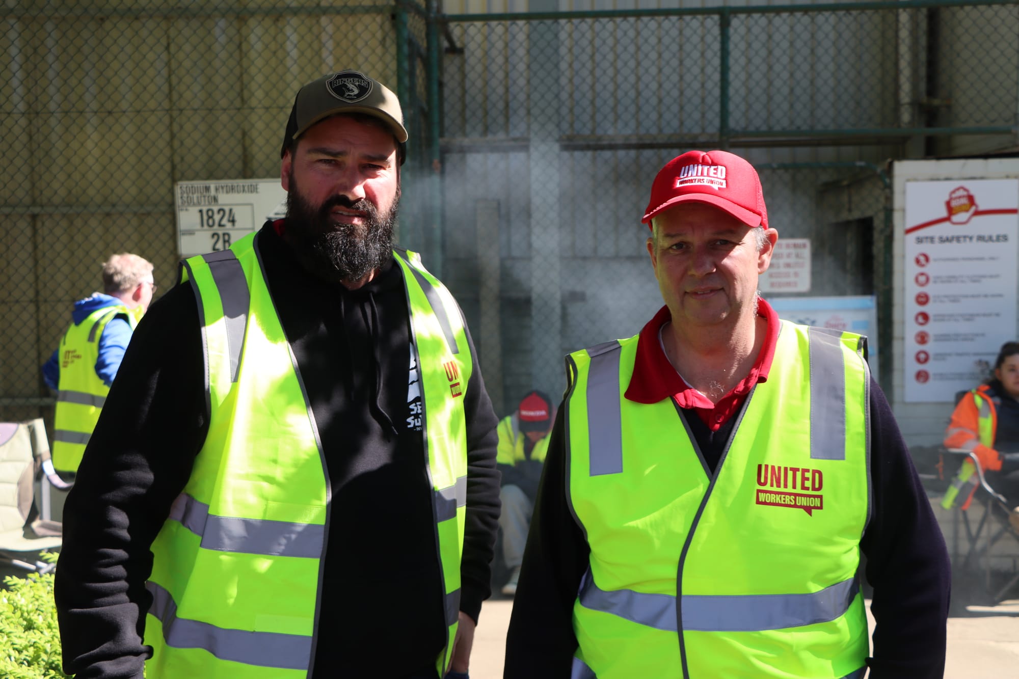 Union delegates Clint Munn and Con Tringas take part in industrial action outside Saputo in Leongatha on Wednesday.