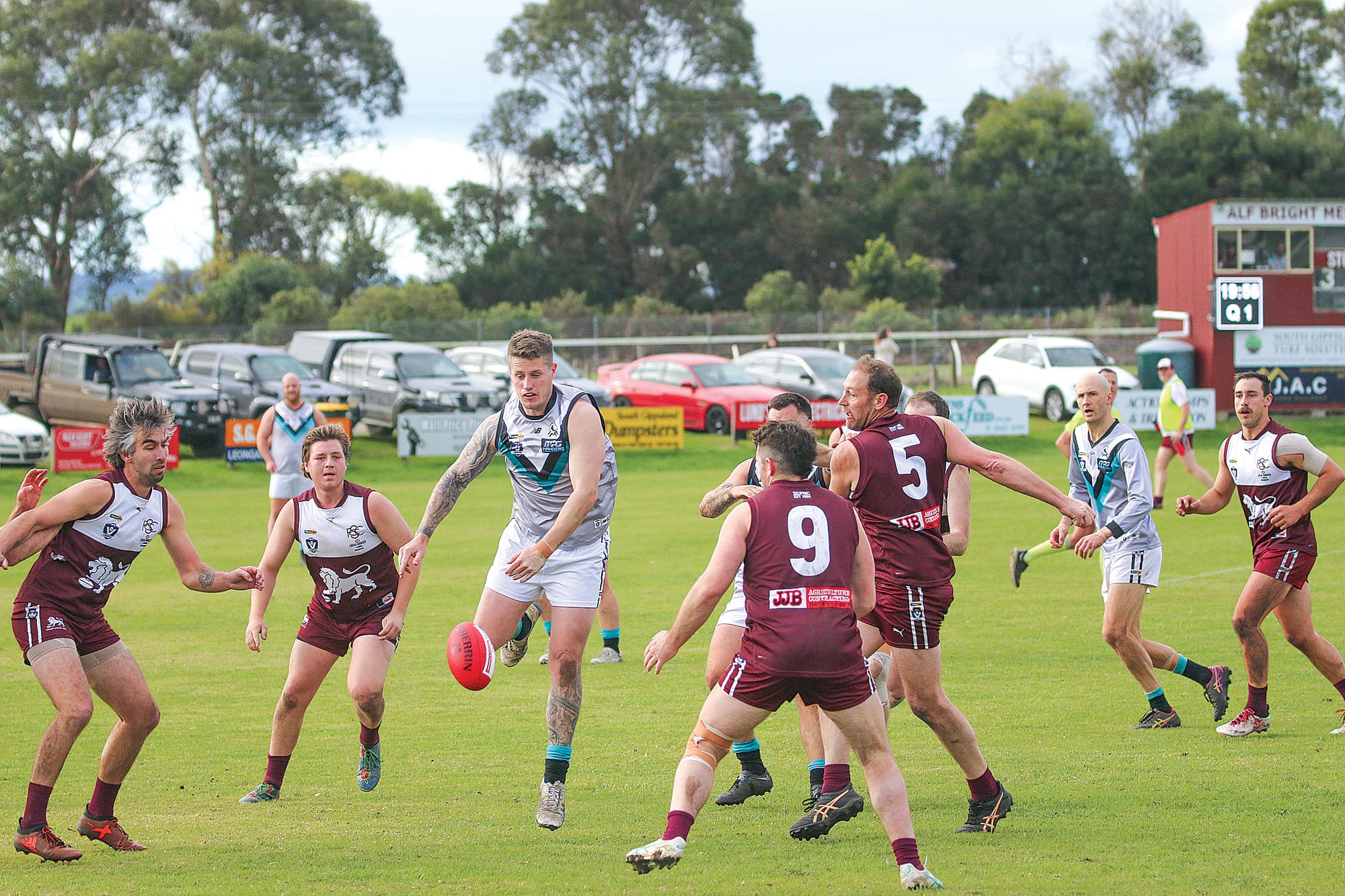 Tige Renwick races after the ball in an effort to gain control between a guard of Lions.
