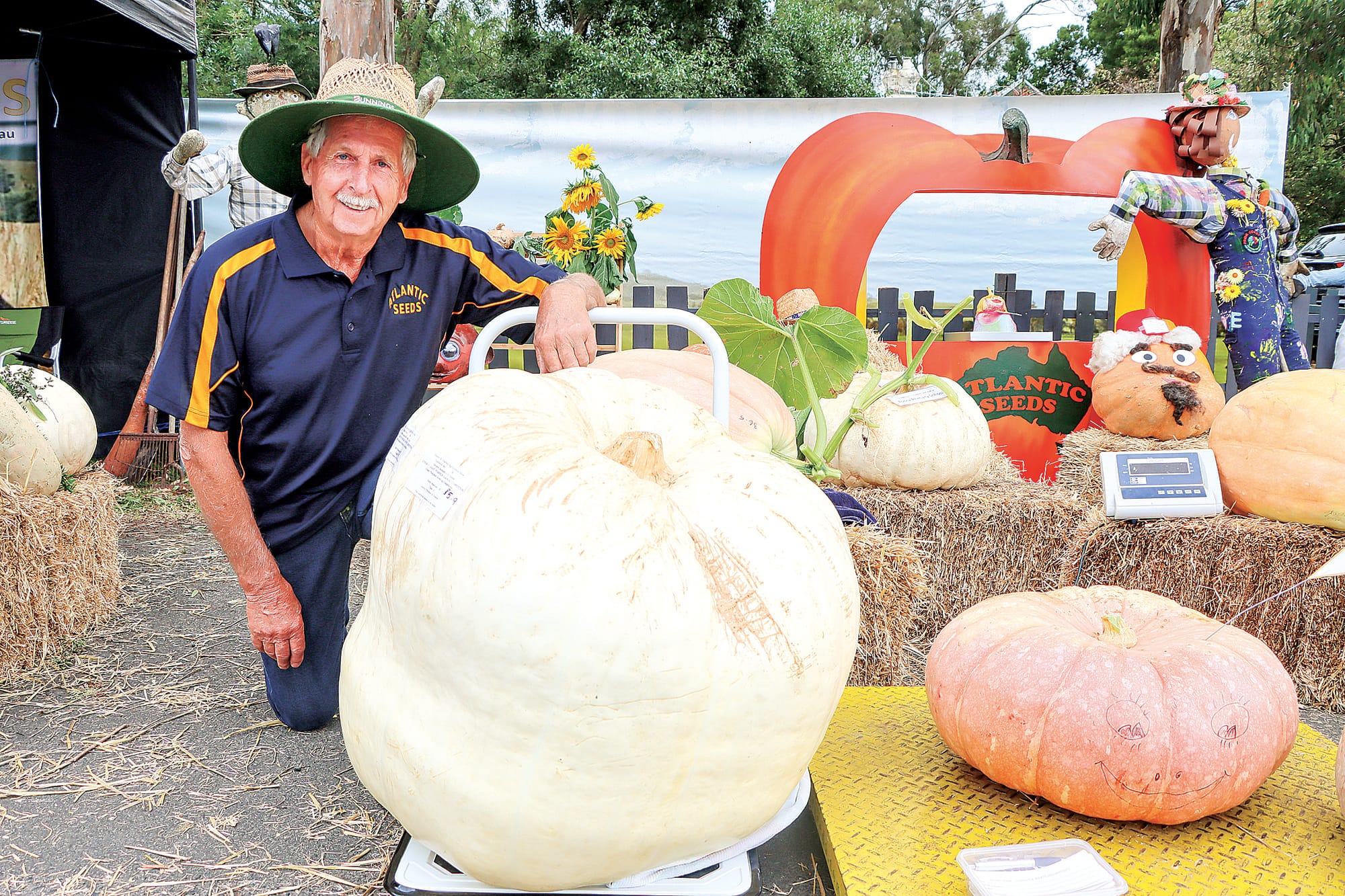 Nyora’s Paul Latham at the Atlantic Seeds pumpkin competition area with Alana and Liam Sage’s 85.9 kilo whopper. A12_0924