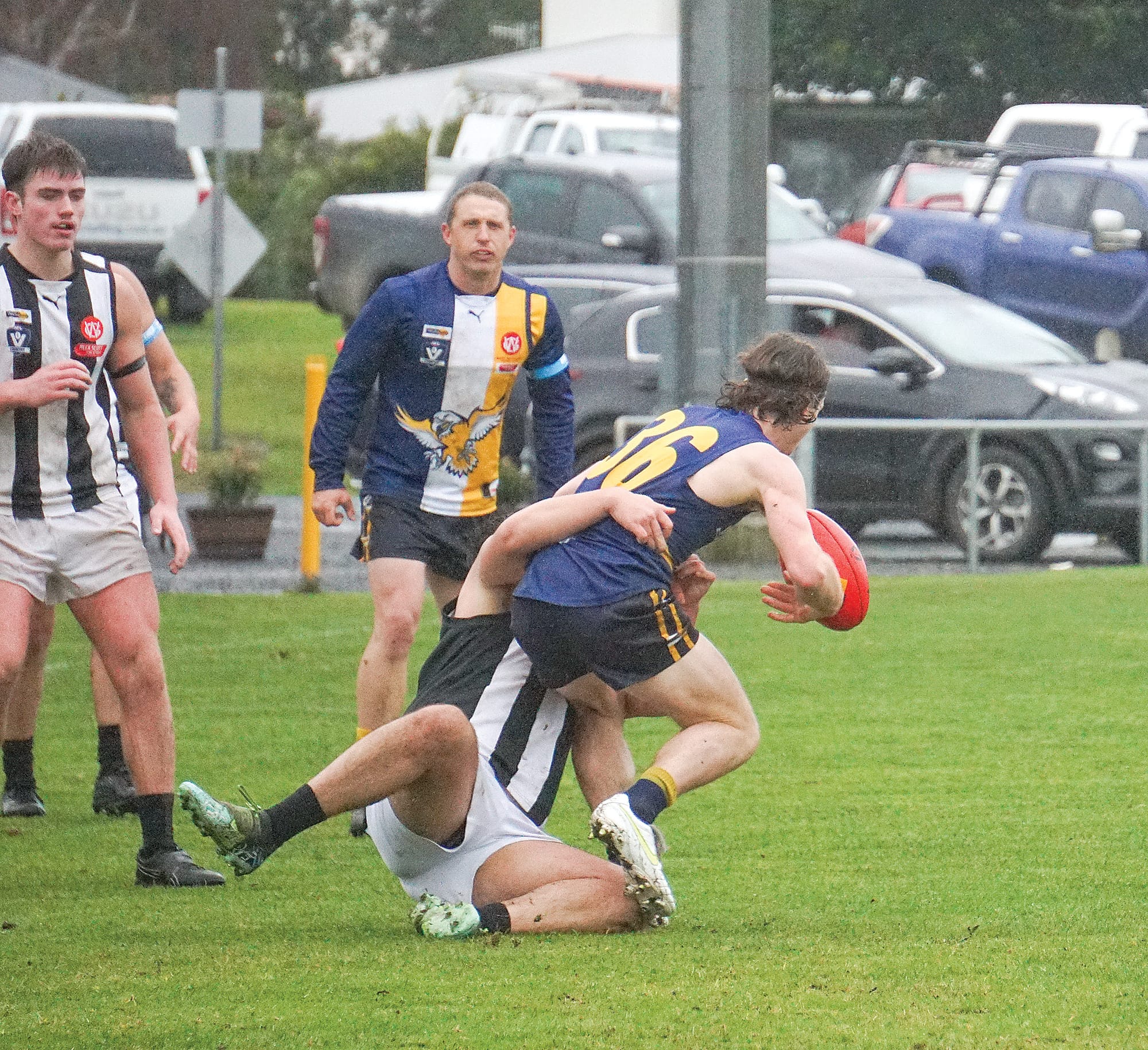 Inverloch’s Reegan Kemp looks for options as he goes down. Ns02_3024