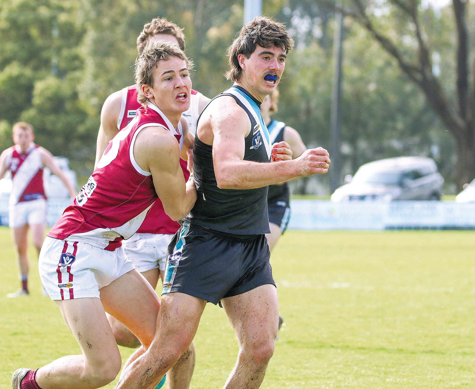 Jaxon Williams handballs it off safely. 