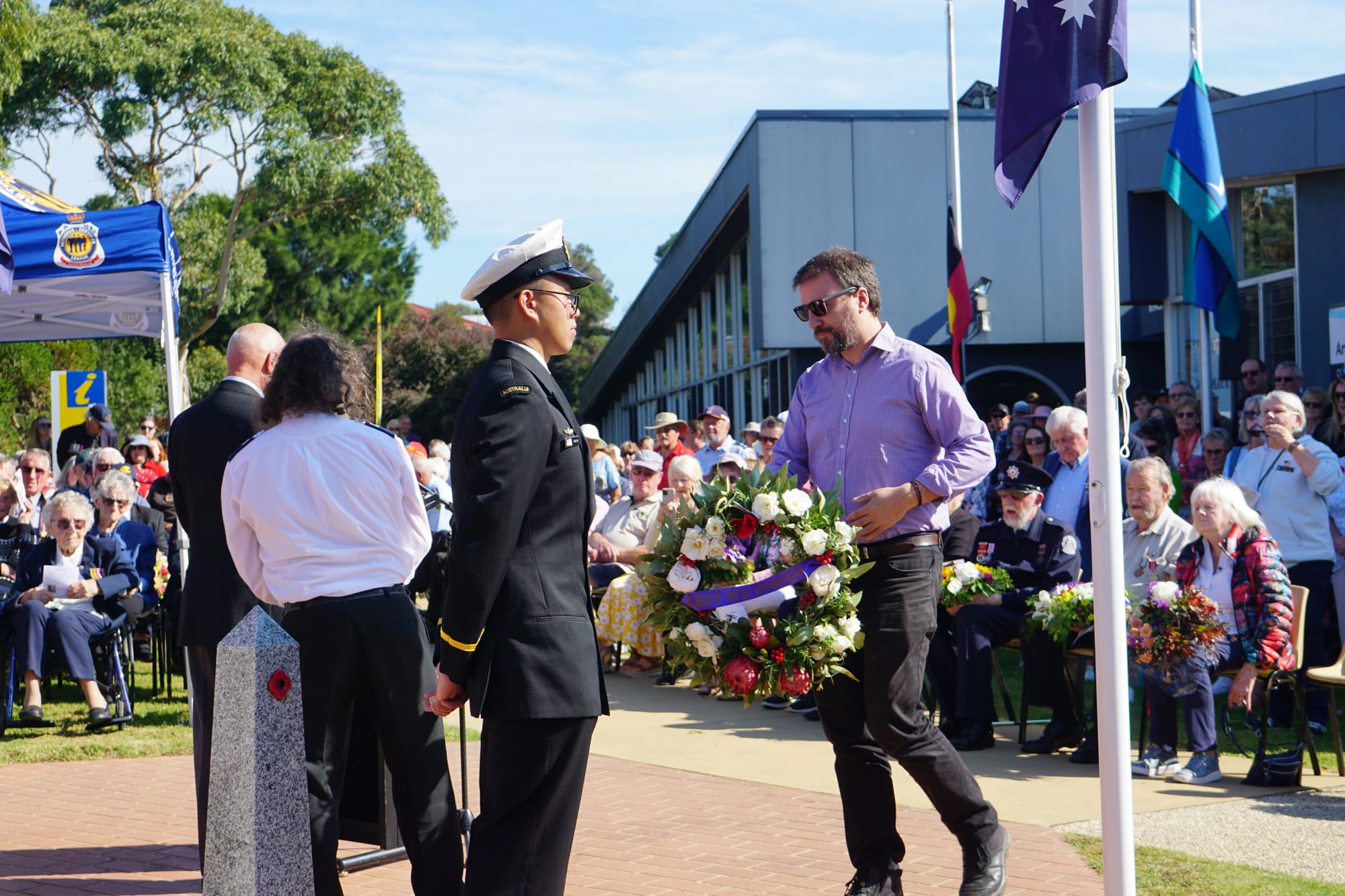 A representative of Bass Coast Health prepares to lay a wreath. 