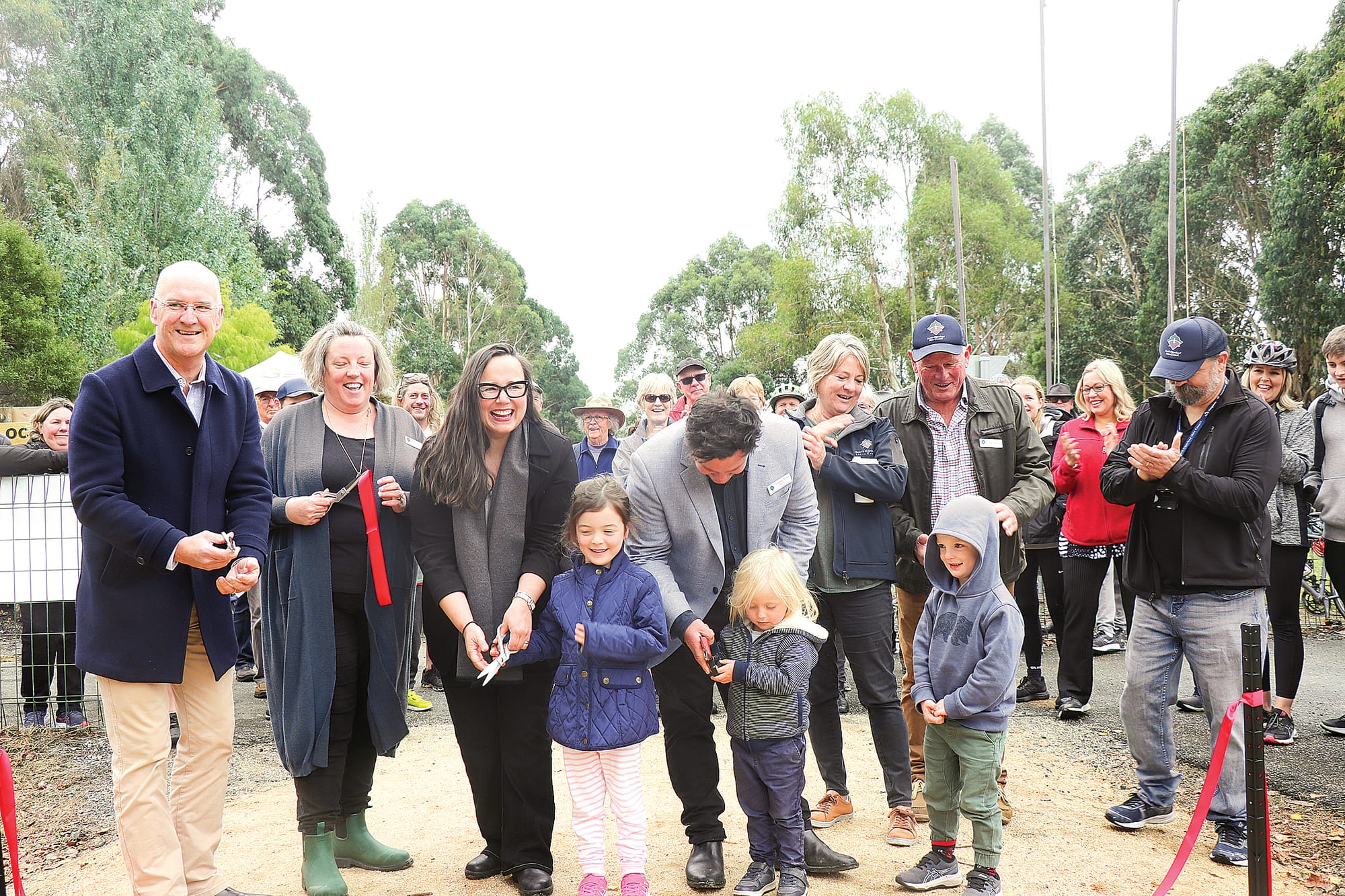 MP Danny O’Brien, CEO Kerryn Ellis, Minister for Regional Development Harriet Shing, Mayor Nathan Hersey with son Hugo, Cr Jenni Keeri, Cr John Schelling, and Cr Mick Felton cut the ribbon for the official opening of the Great Southern Rail Trail Extension between Nyora and Leongatha. Z03_1423 
