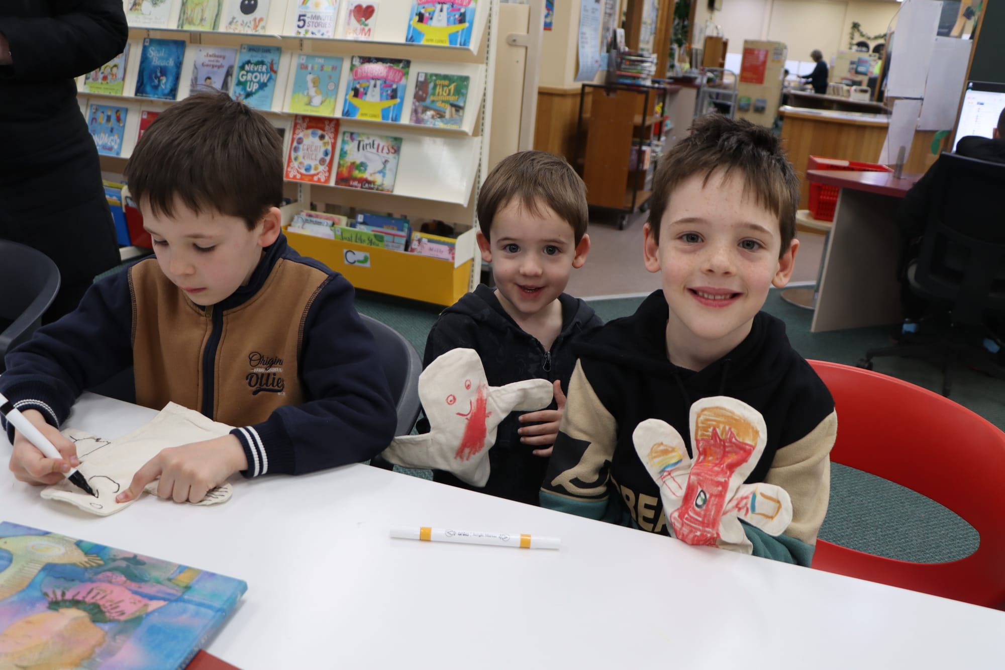 Locals Darcy, Ryder and Blake Cholmondeley enjoy the NAIDOC Week puppet making session at Leongatha Library.
