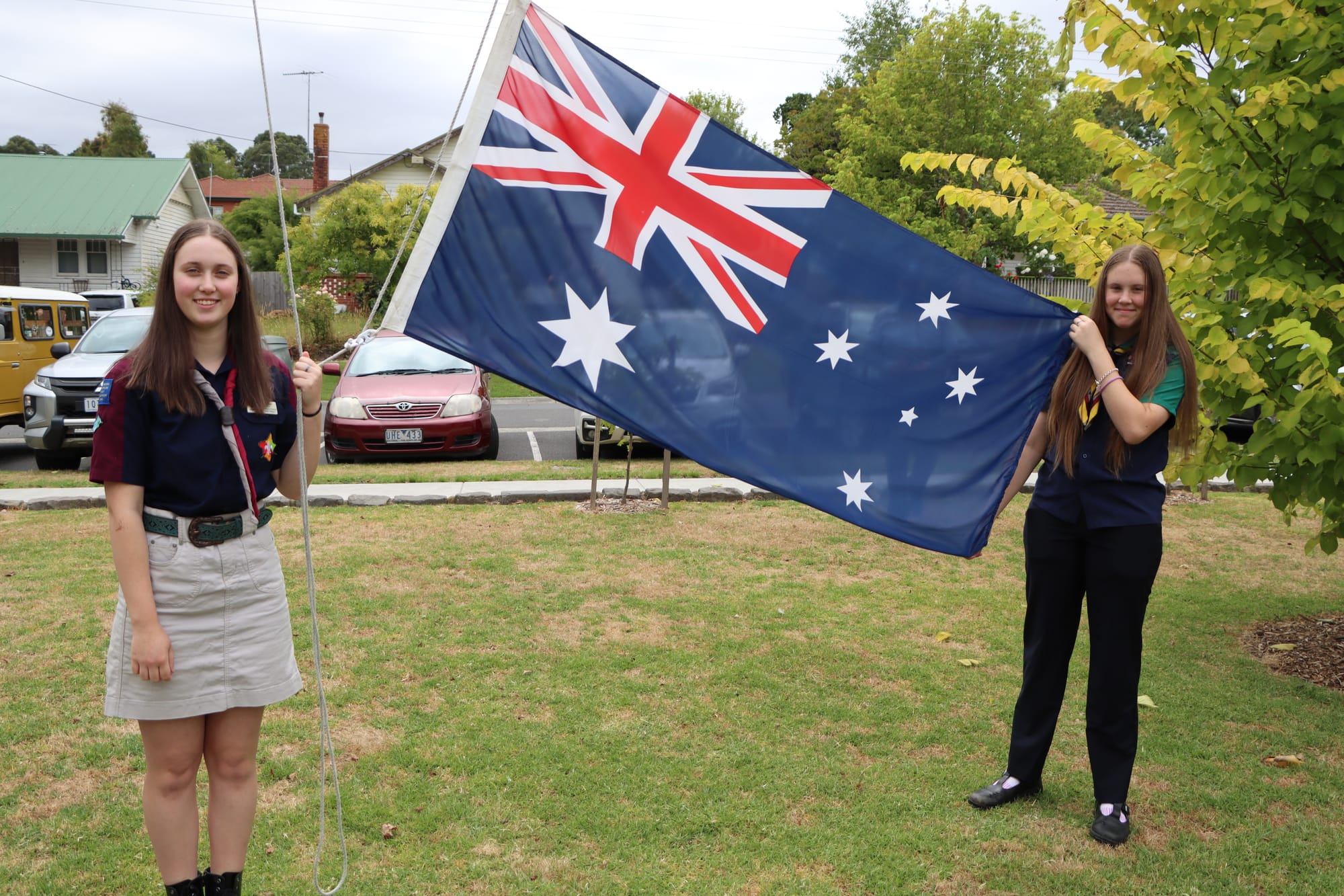 Sisters Danni and Charlotte Amor of Coal Creek Venturers and 2nd Korumburra Scouts respectively prepare to raise the flag in Korumburra’s Coleman Park.