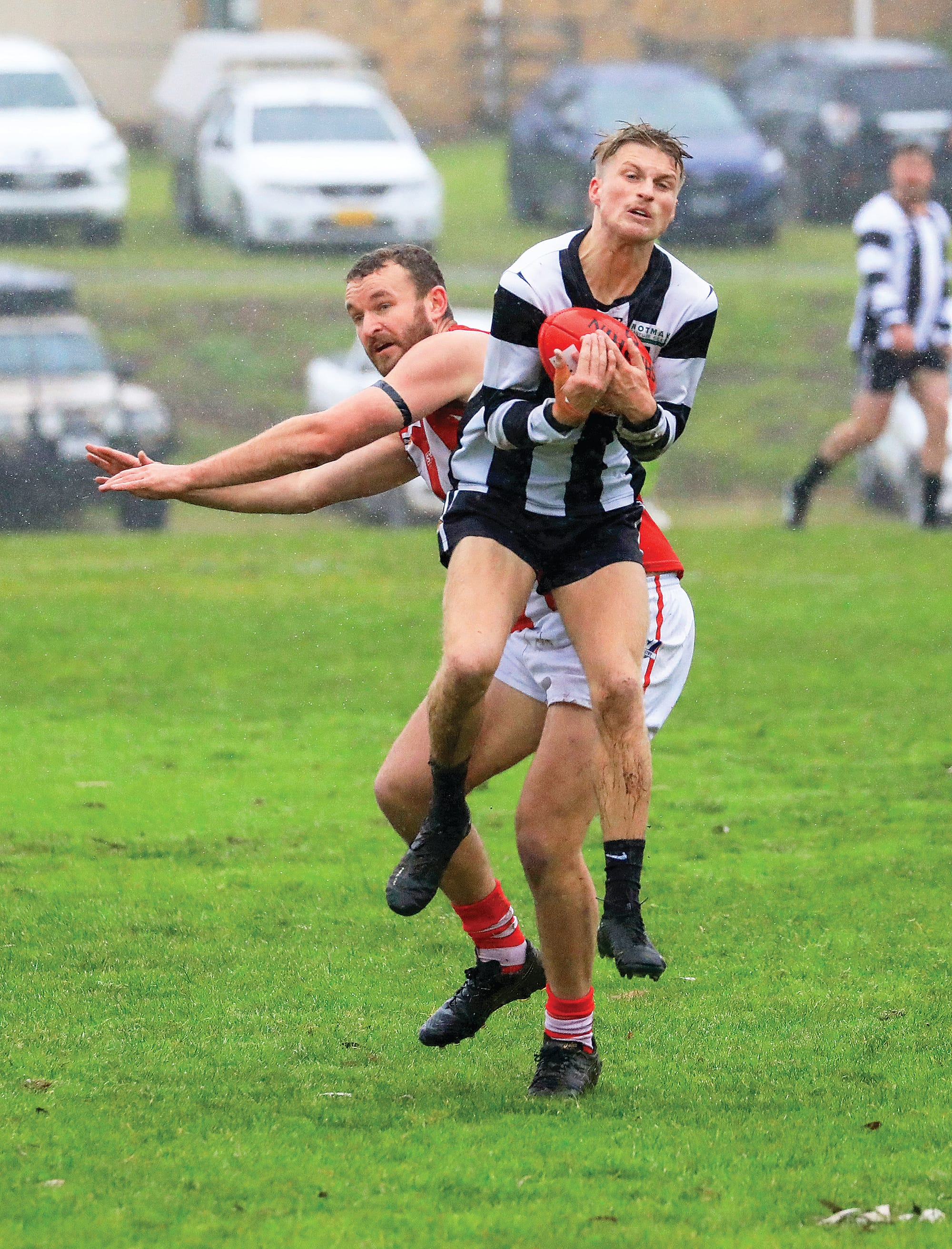 The rain didn’t dampen Alex Henshall as he secured the mark against his Trafalgar opponent. Photo: Jeff Tull.