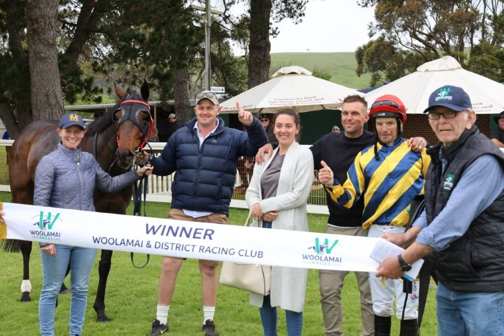 Connections of Race 4 winner, Rule Of Salex, with winning jockey Leigh Taylor and Woolamai committeeman Peter McCluskey pose for a victory photo in the mounting yard.
