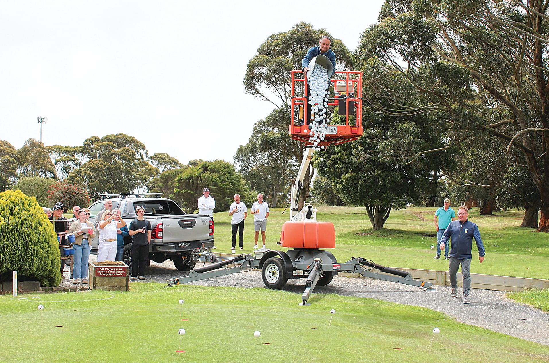 Scott Adams releases the balls in the Golf Ball Drop, with Simon Pegg’s ball landing in the winning hole, at the Bass Coast Health charity golf day. 