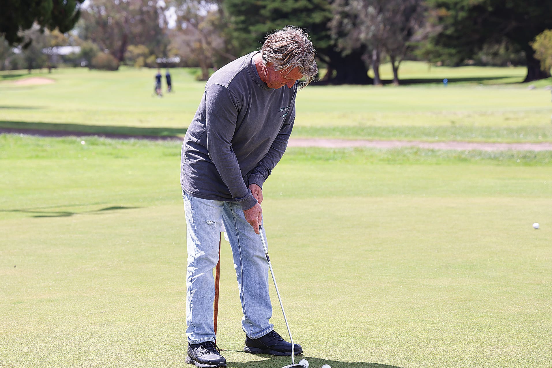 Putting in some practice on the putting green, Surf Beach golfer Adrian Crane. B77_4625