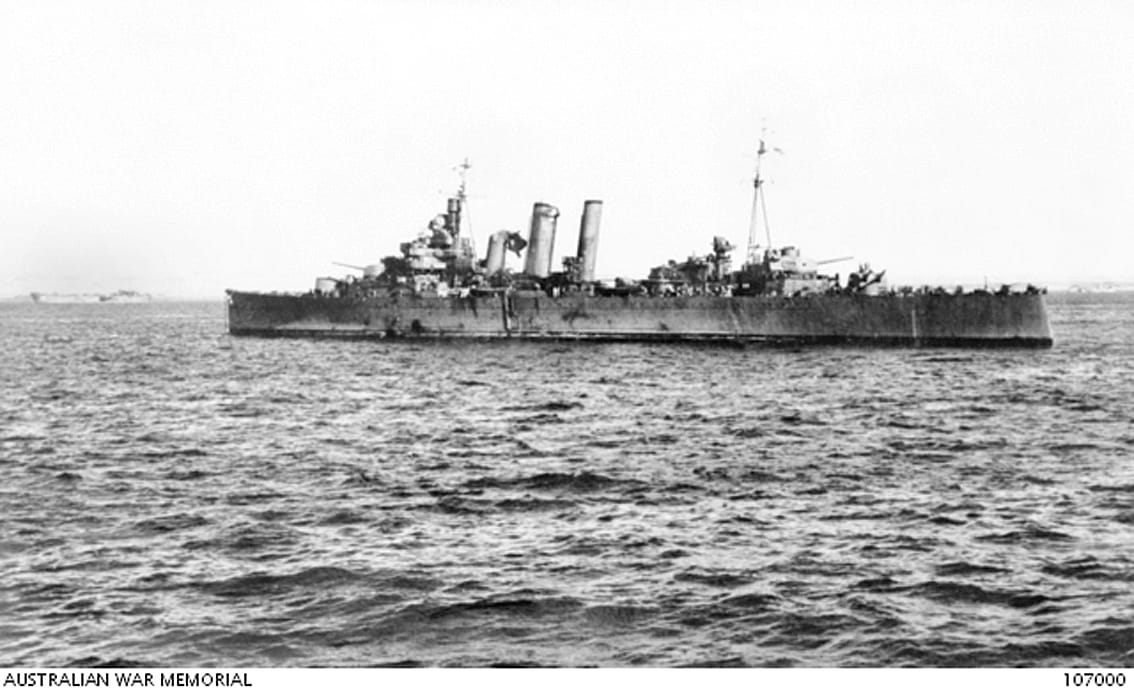 Lingayen Gulf, Philippines, January 9, 1945. HMAS Australia showing damage incurred from attacks by Japanese Kamikaze aircraft in Lingayen Gulf during the Luzon campaign. This photograph was taken from the USS West Virginia. (US National Archives Neg. No BB48-0272). Photo: Australian War Memorial Collection.